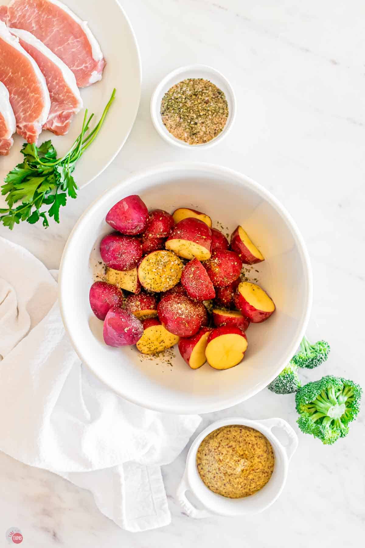 baby potatoes cut in half and in a white bowl