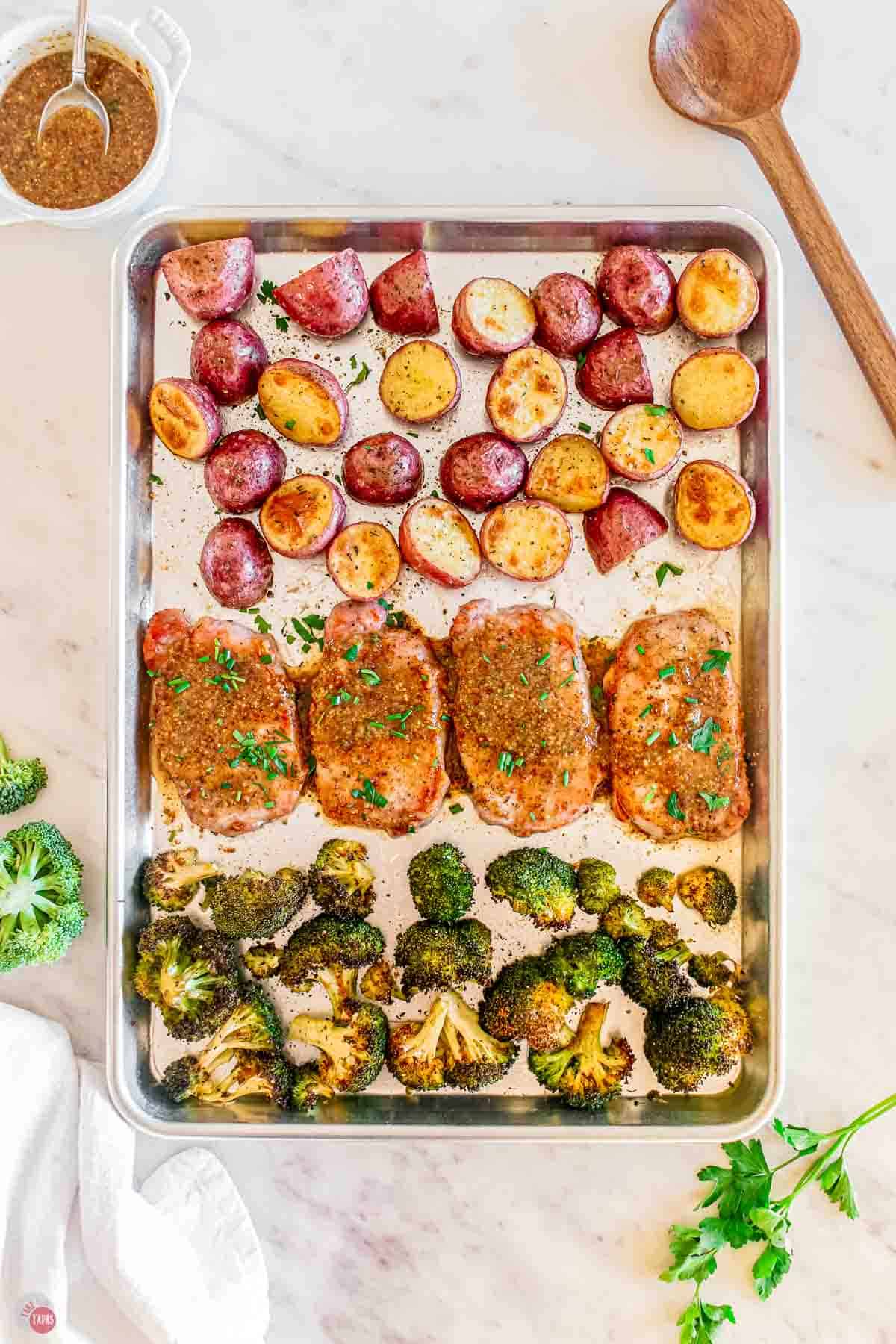 baking sheet with roasted pork chops and vegetables