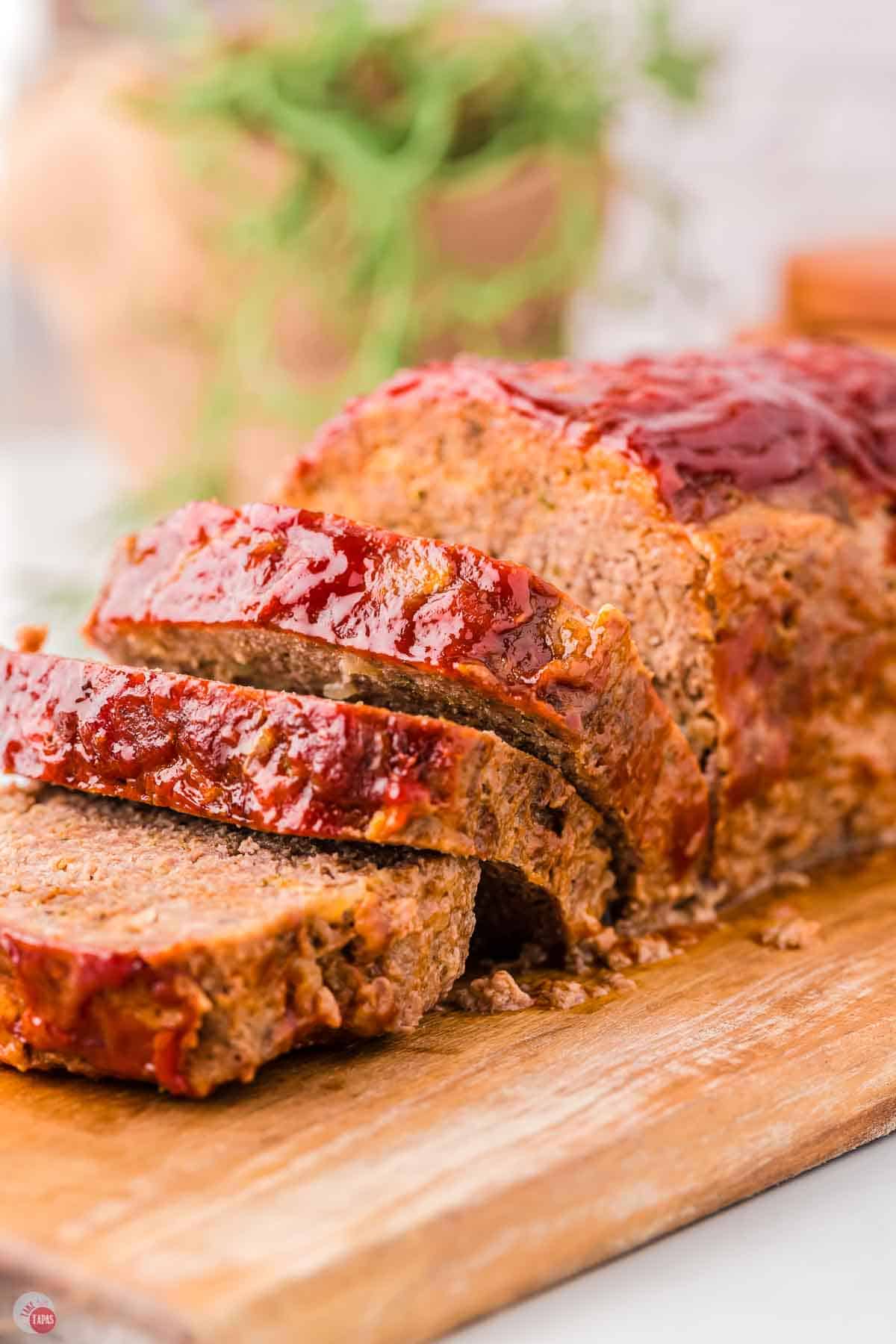 slices of meatloaf on a wood cutting board