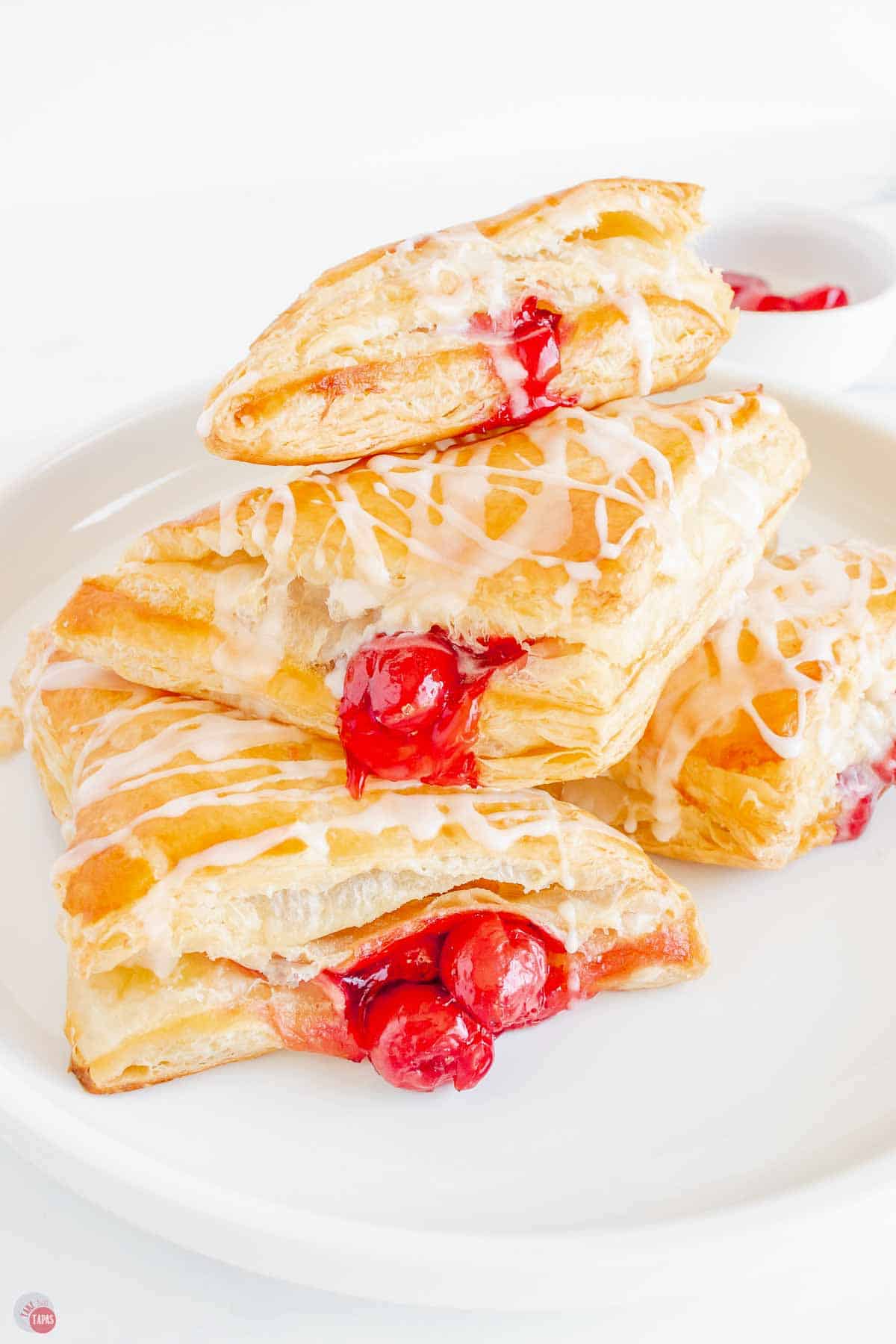 stack of puff pastry turnovers on a white platter