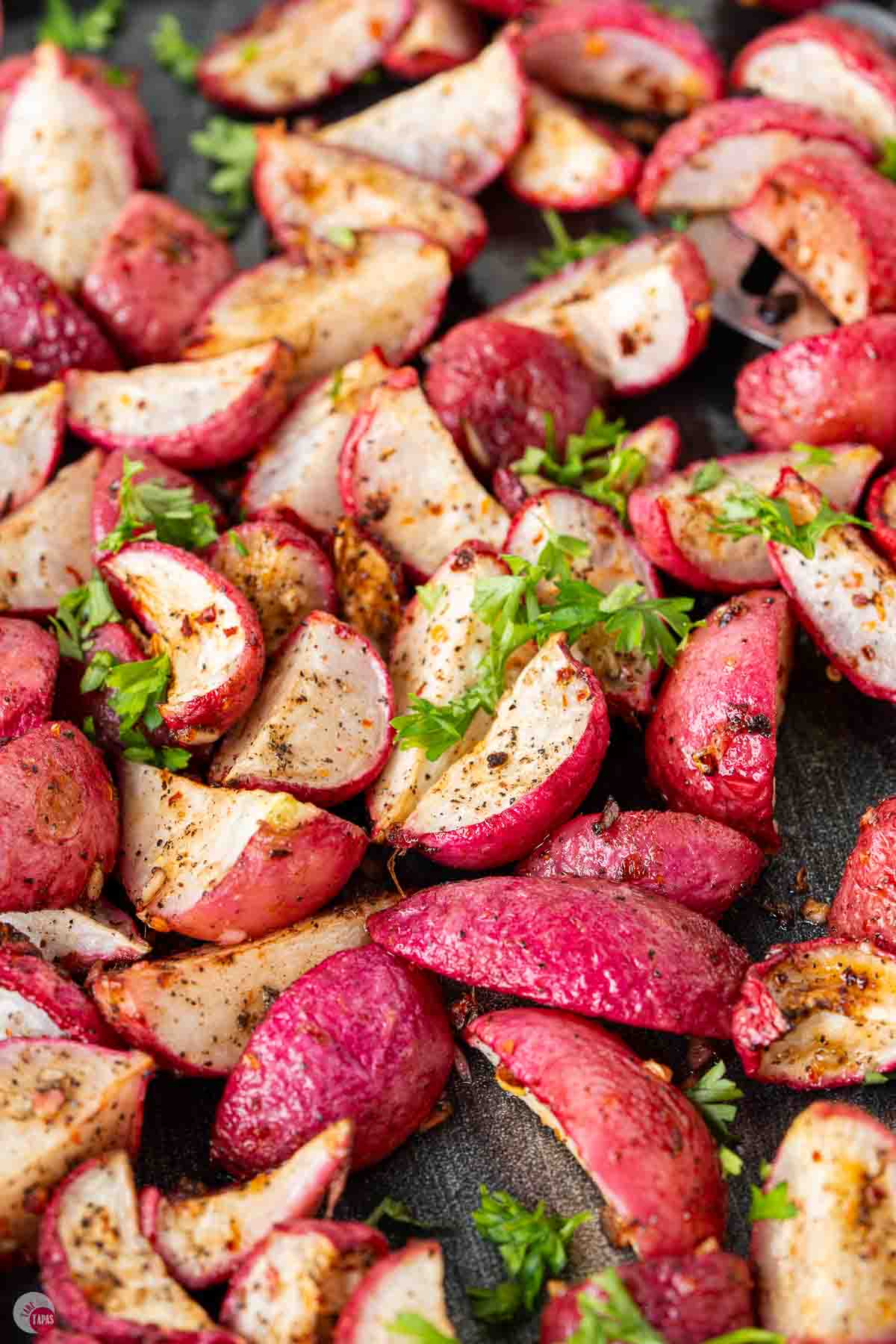close up of radishes cooked in the oven with garlic and olive oil