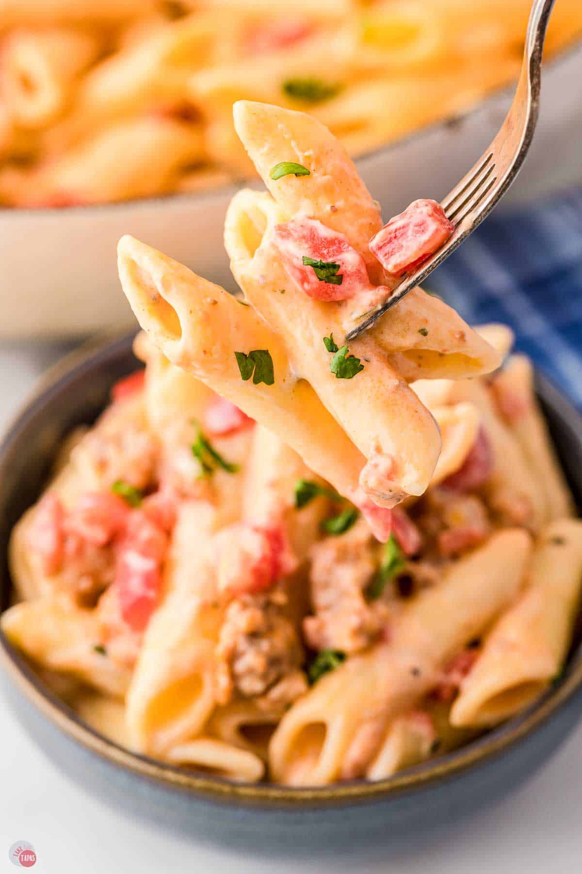 fork with bite of pasta over a bowl