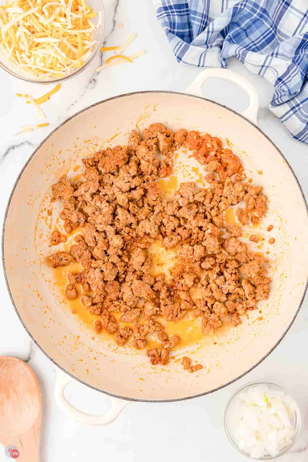 cooked Italian sausage in the bottom of a large skillet