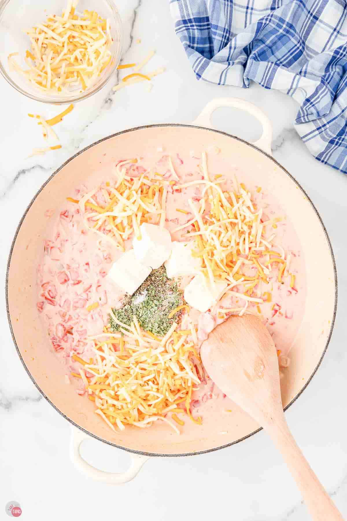skillet with creamy sauce being stirred
