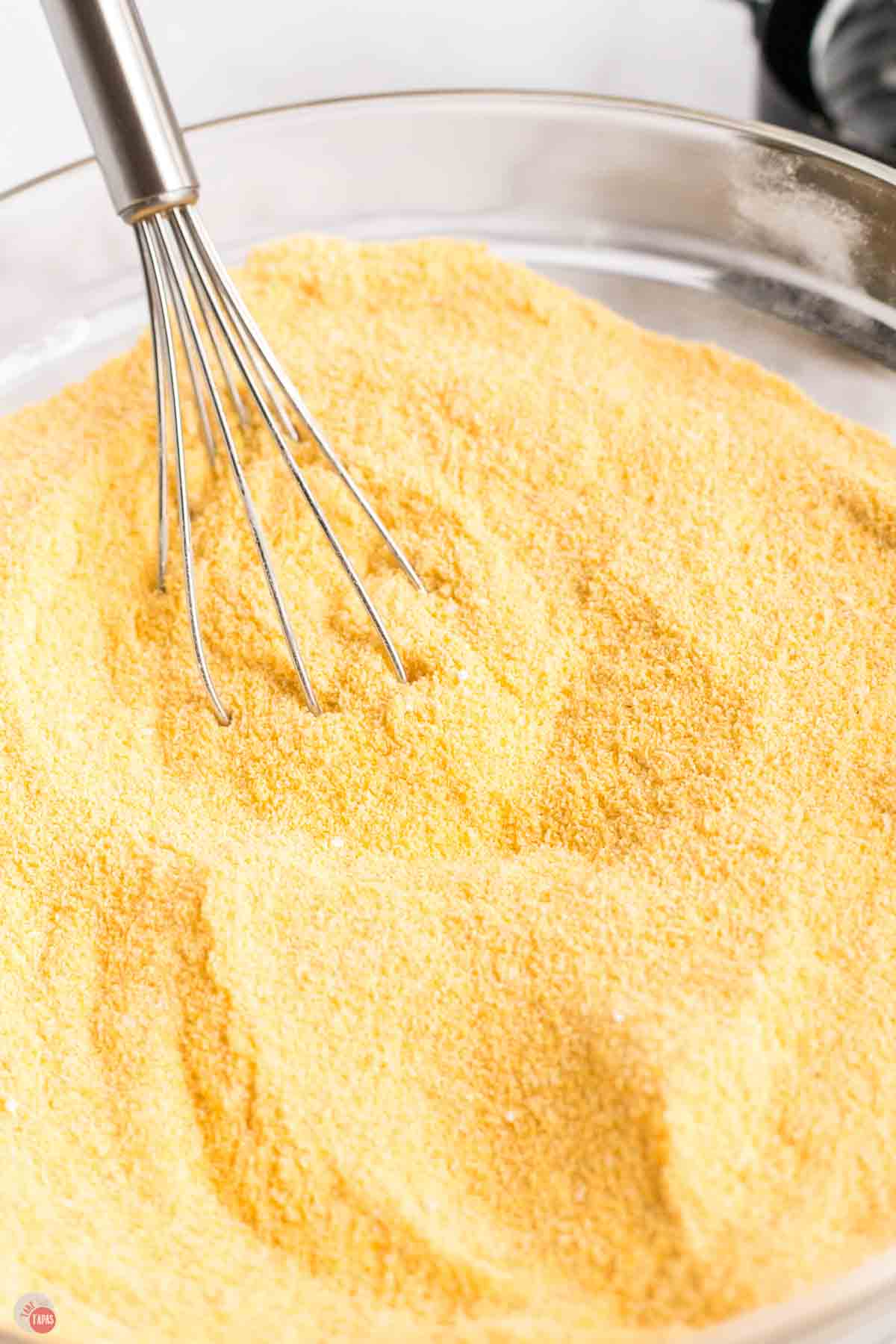 close up of cornmeal mix in a clear bowl