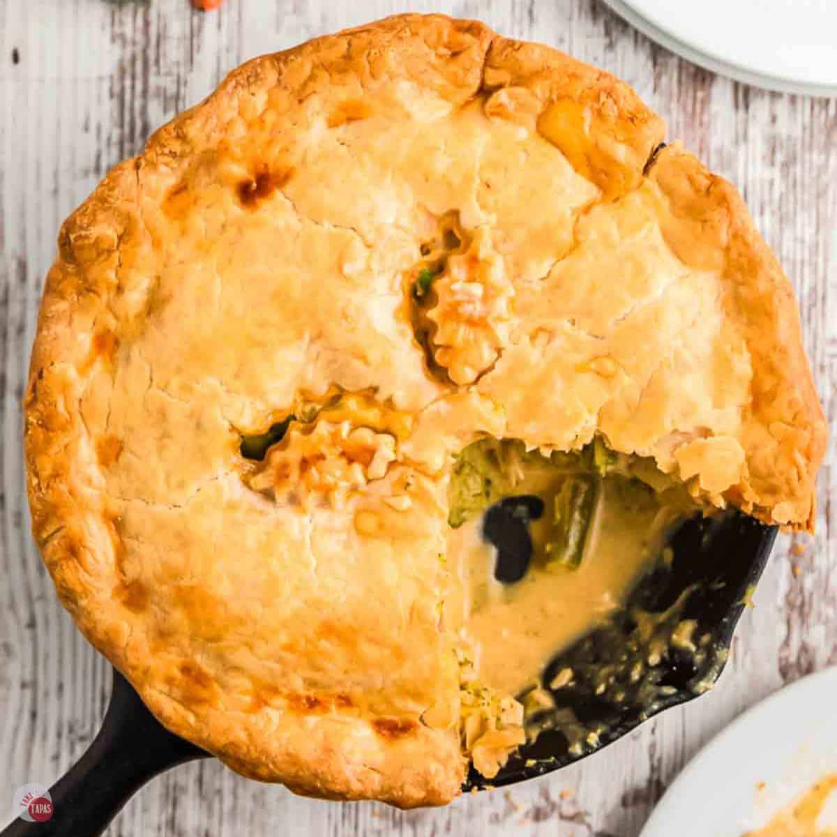 cast iron skillet chicken pot pie with a wedge missing