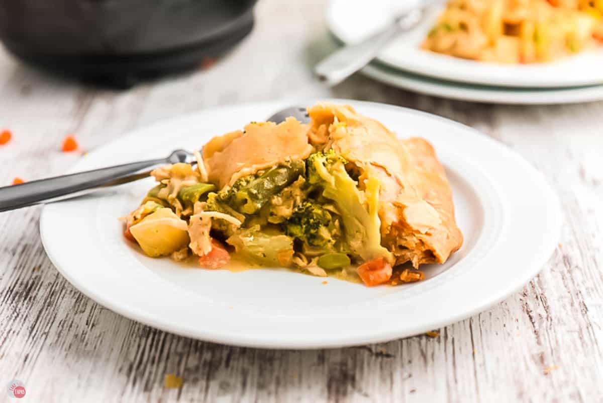 Slice of chicken pot pie on a white plate