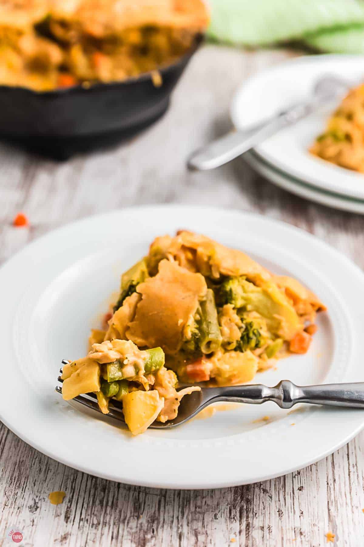 slice of pot pie on a plate with a fork