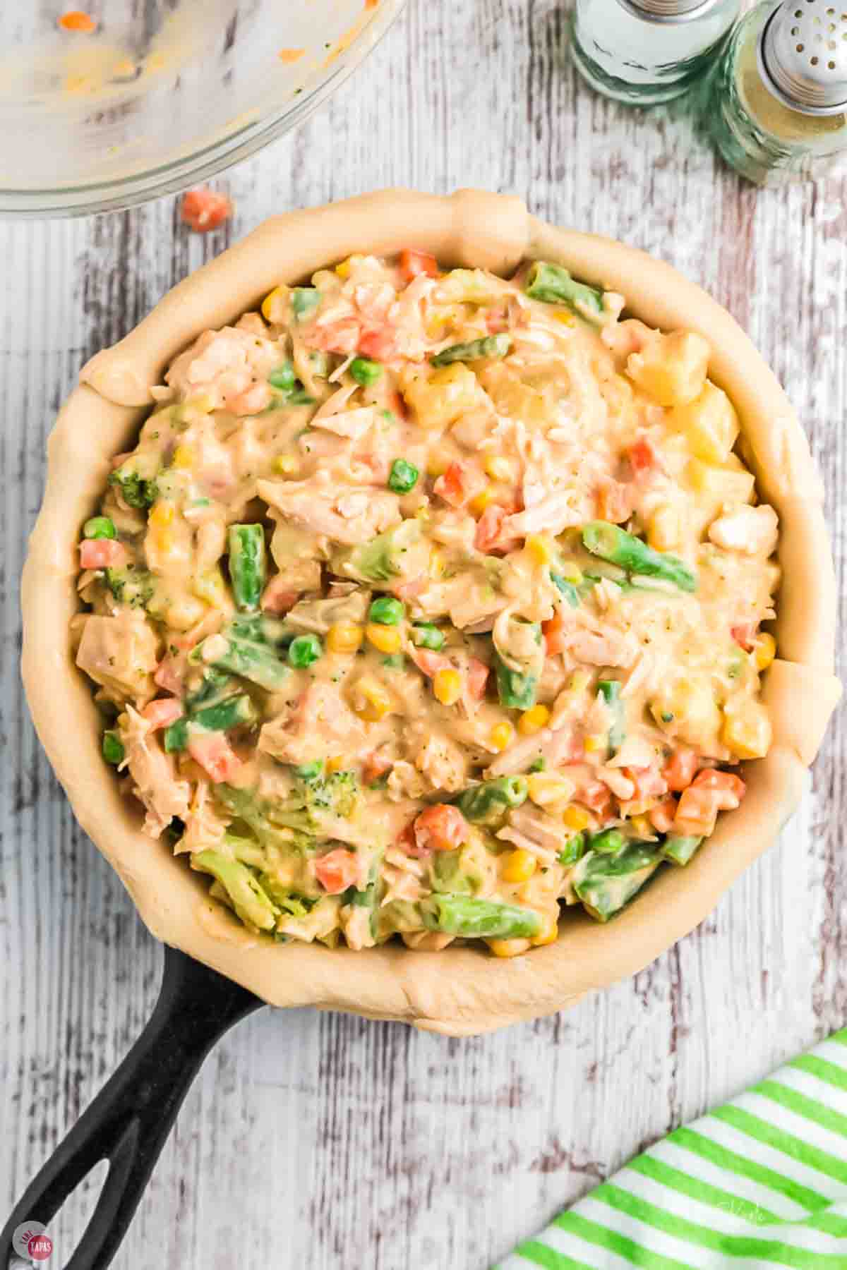 skillet with pie crust and chicken pot pie filling