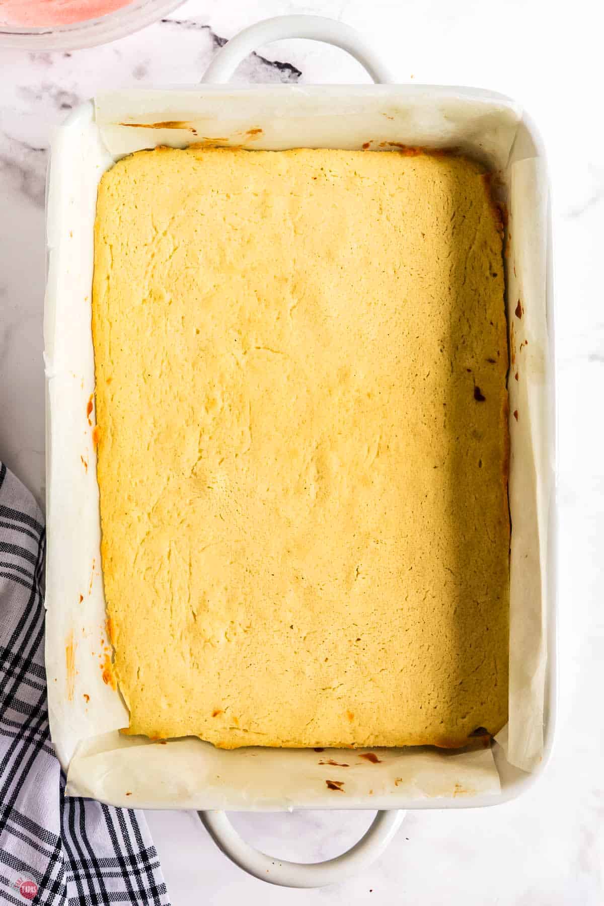 baked cookie layer in a white baking dish