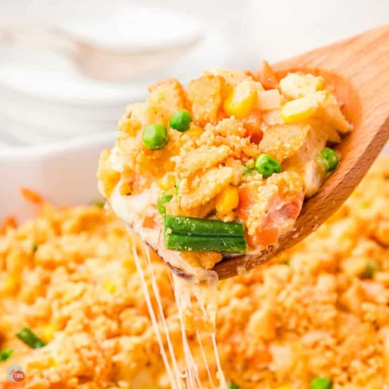 wood spoon with scoop of creamy vegetables