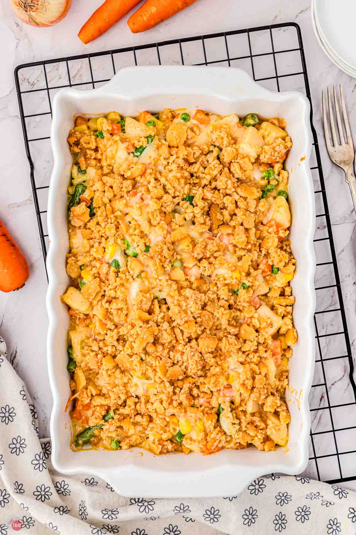 finished baked casserole in a white dish on a wire rack