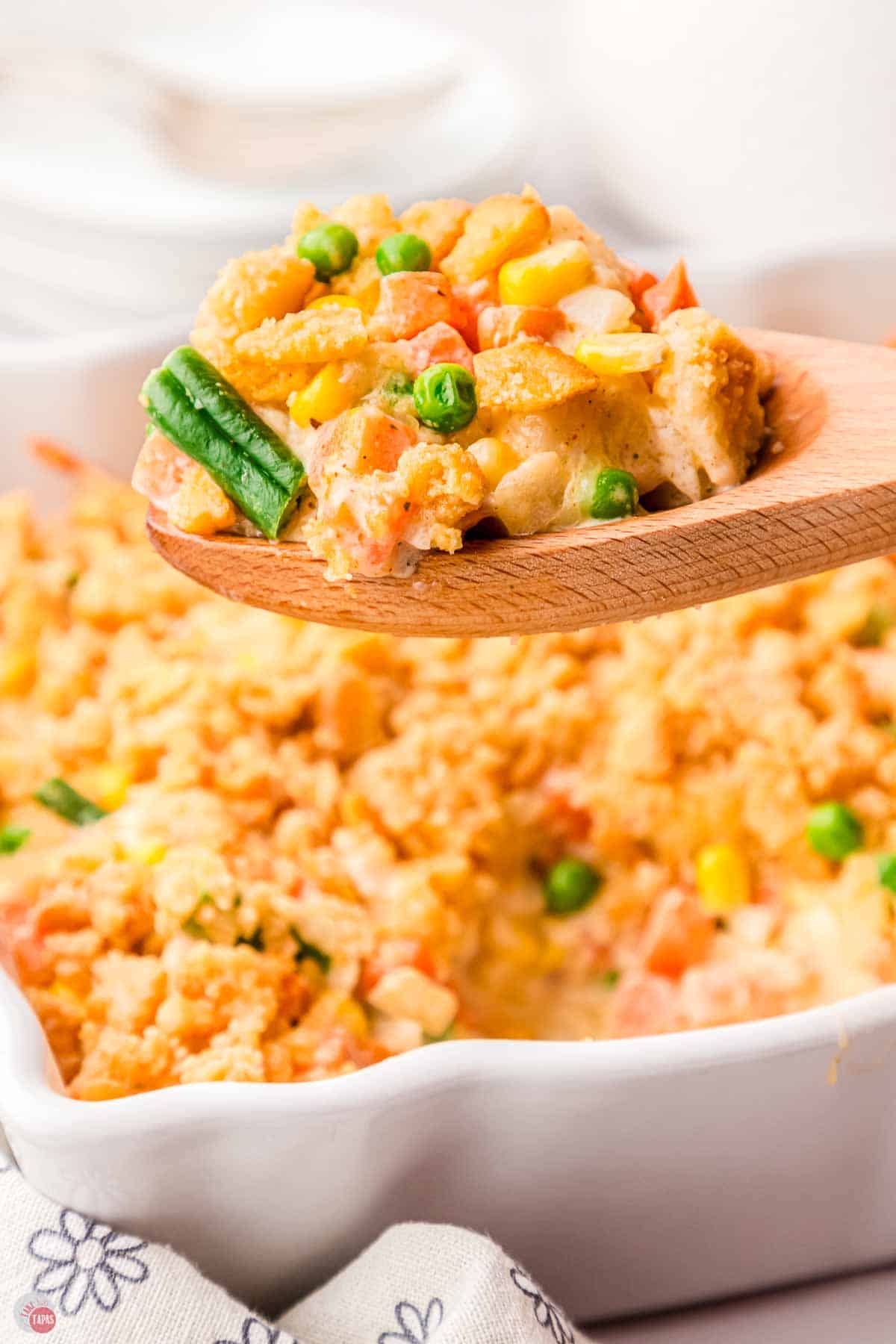 wood spoon with scoop of creamy vegetables