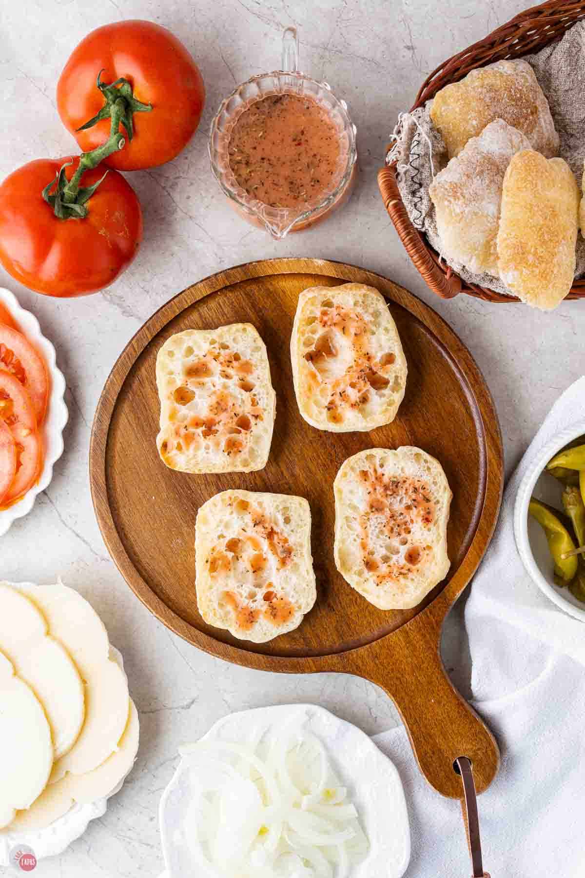 rolls sliced in half and topped with red wine vinaigrette