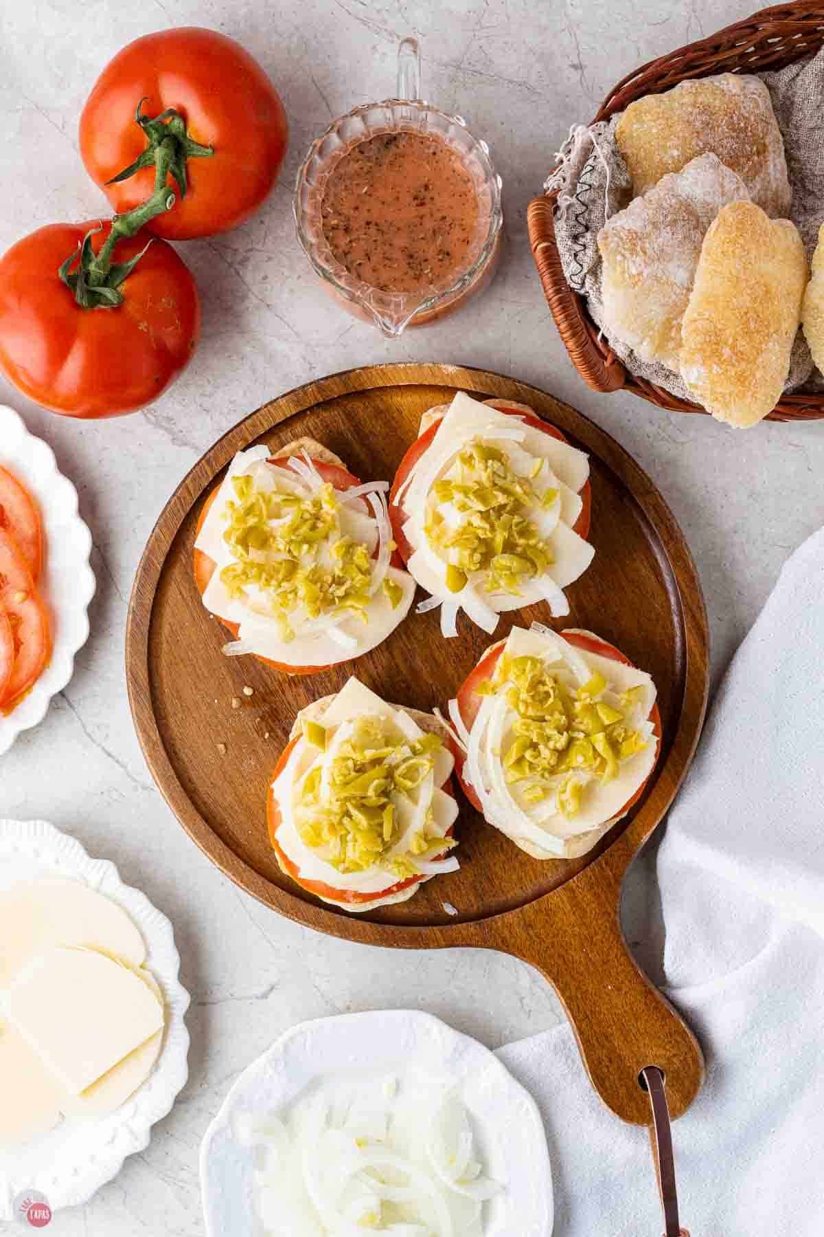 wood cutting board with open faced sandwiches on top