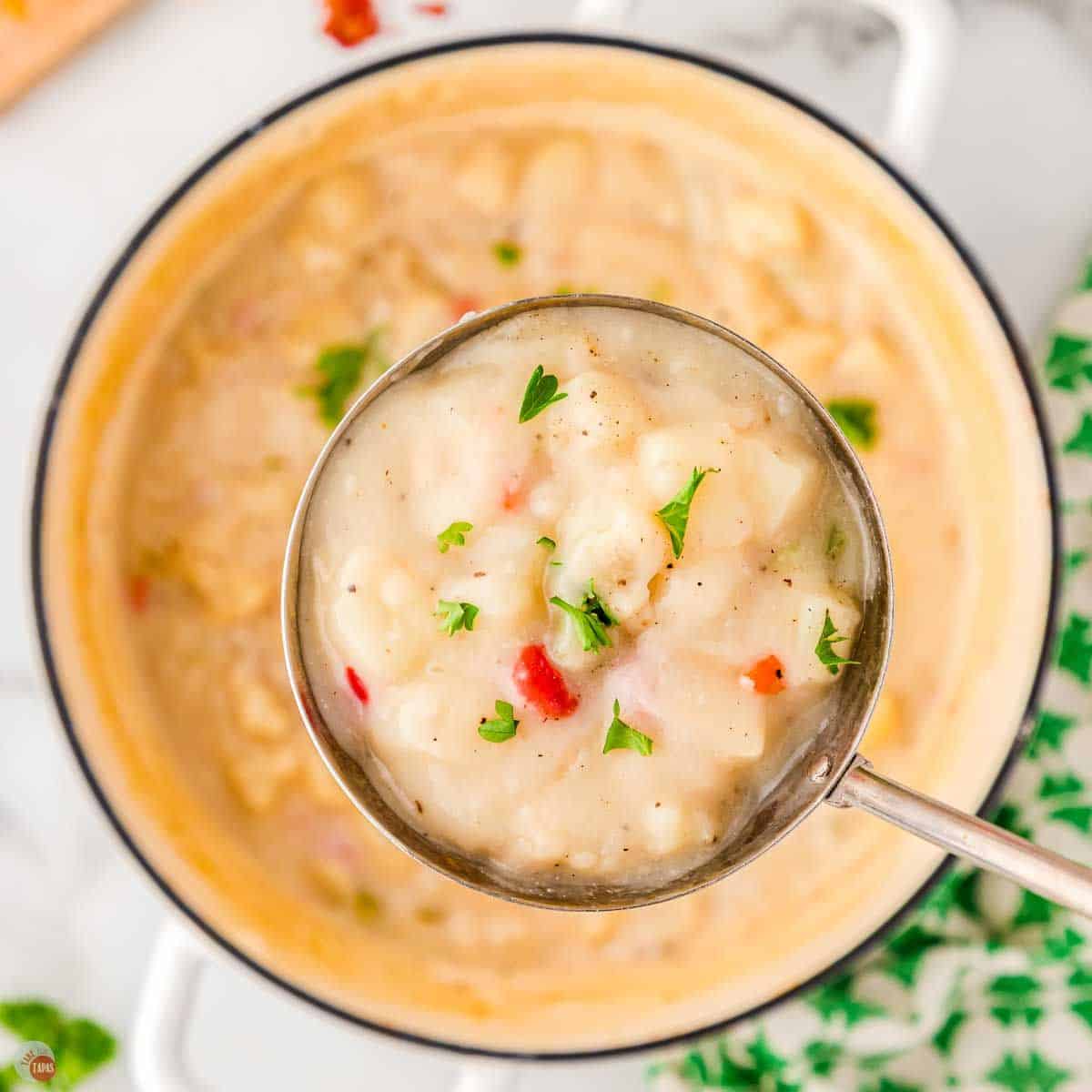 close up of potato soup in a ladle