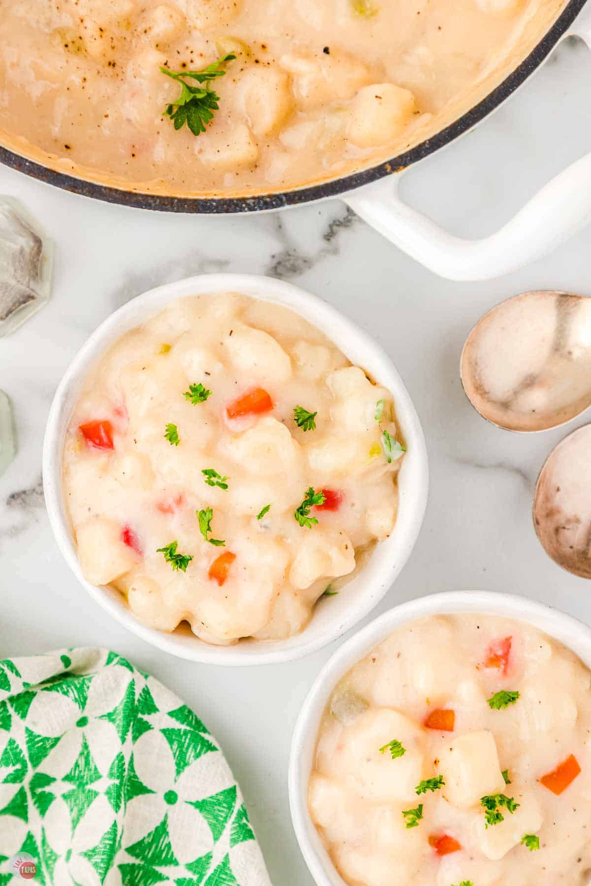 two bowls of soup next to a pot