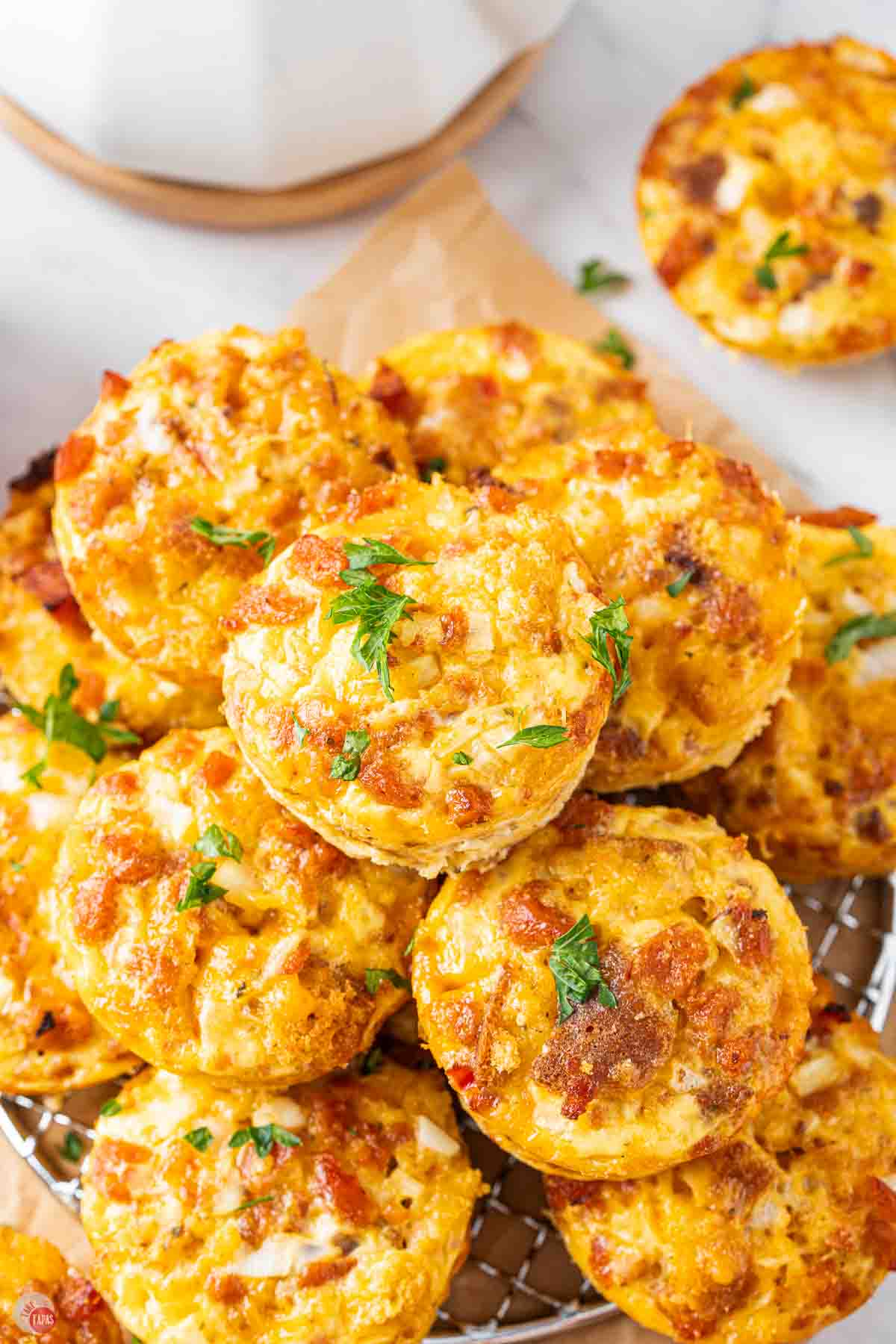 stack of breakfast casserole mini muffins on parchment paper