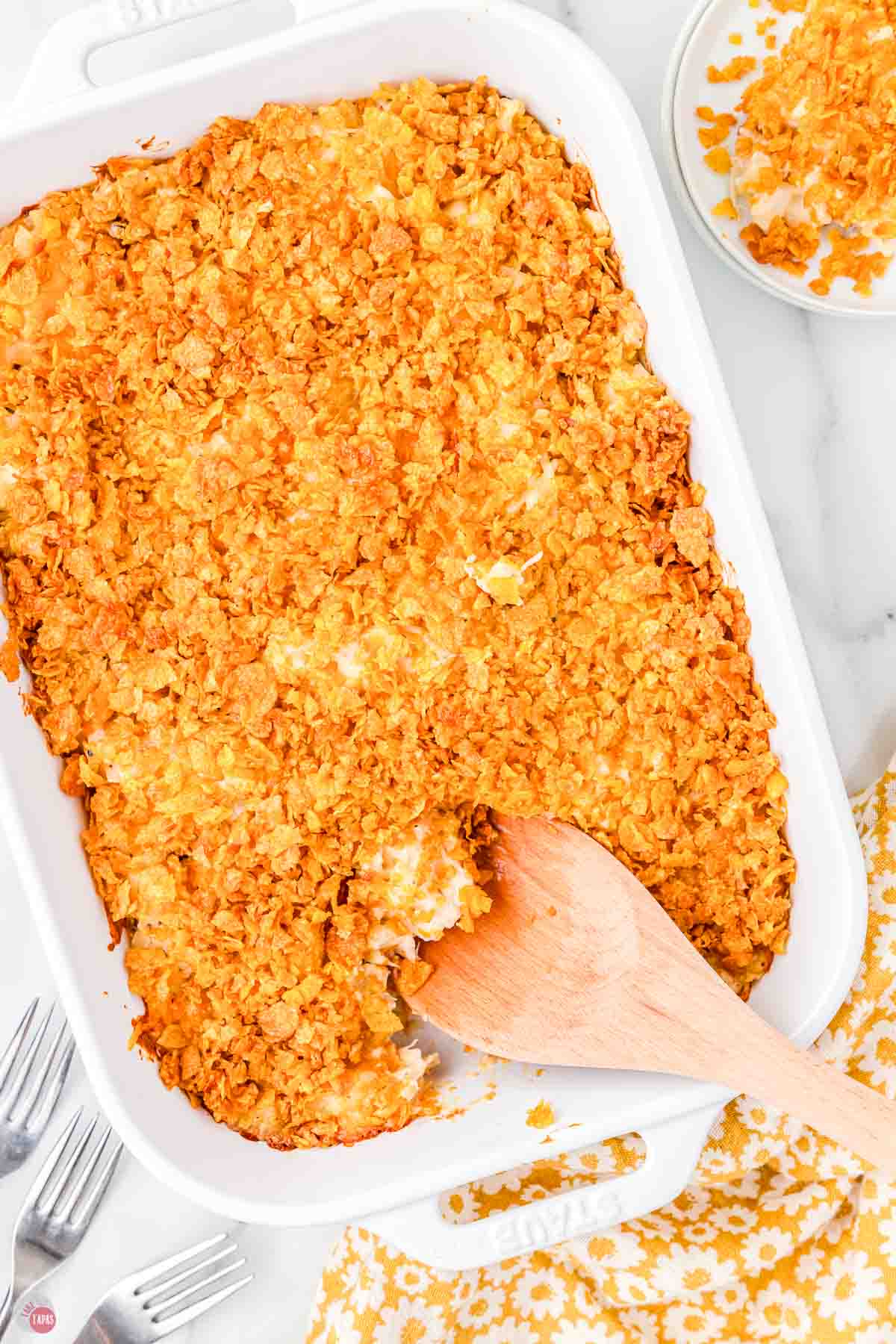casserole with wood spoon scooping some out
