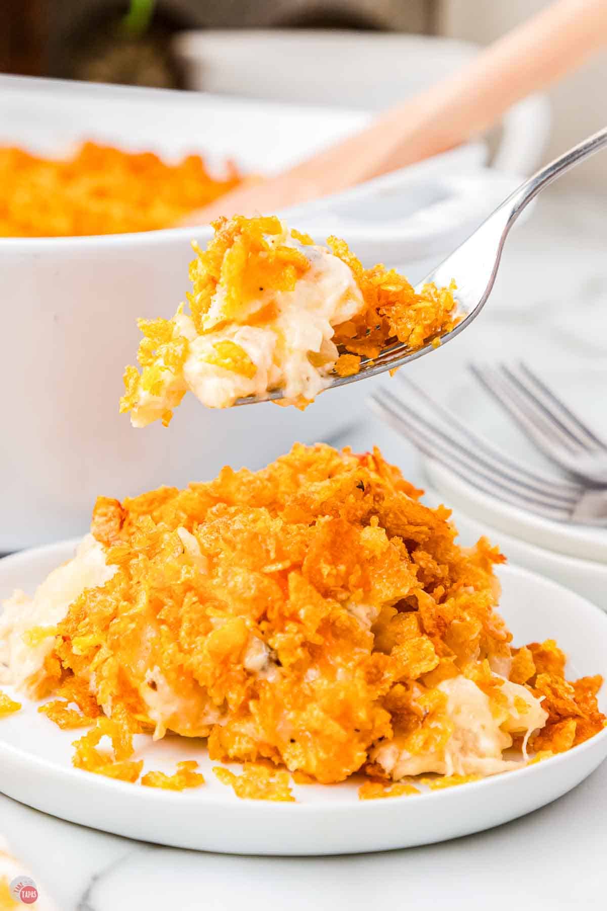 plate with scoop of casserole and a fork lifting a bite