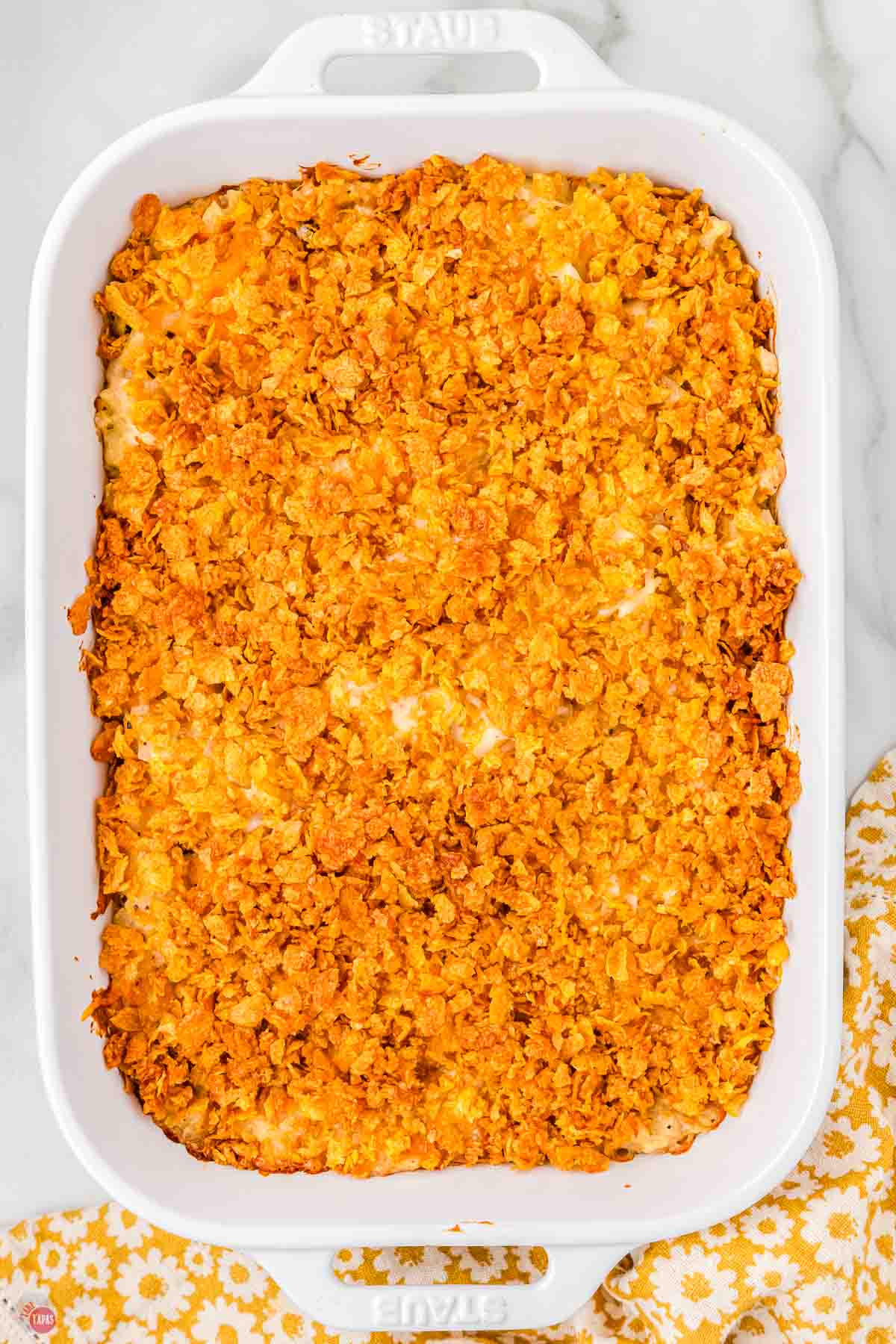 baked chicken hashbrown casserole in a white baking dish