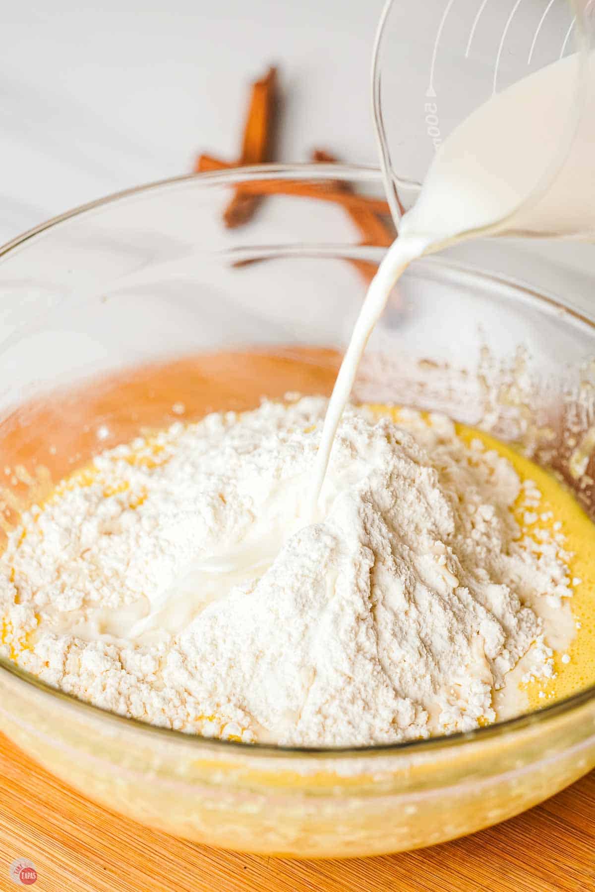 flour and milk being added to a cake batter