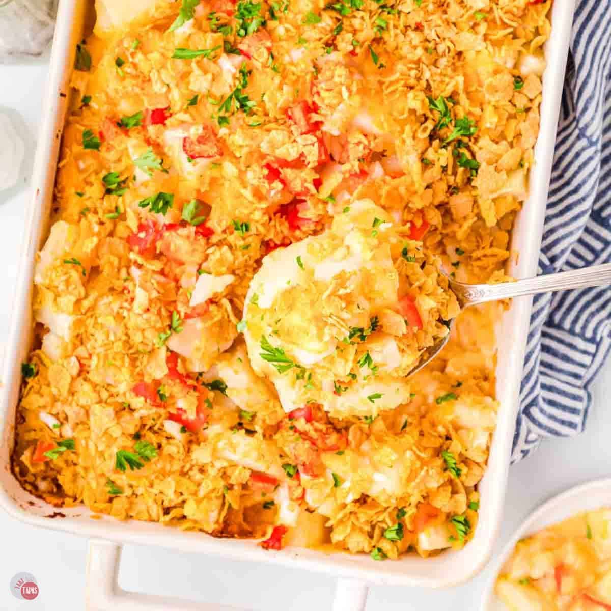 casserole dish with potatoes topped with cornflakes