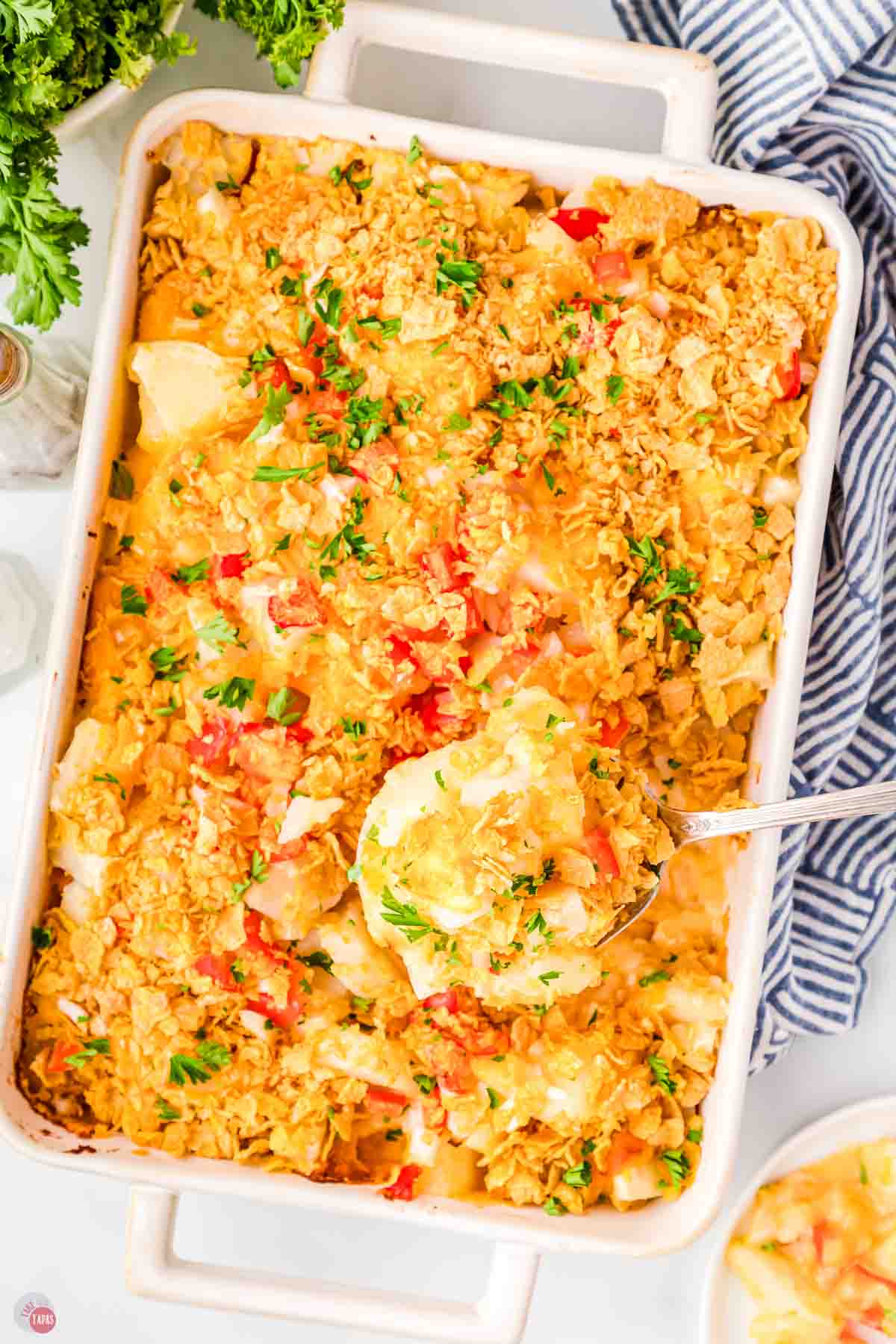casserole dish with potatoes topped with cornflakes