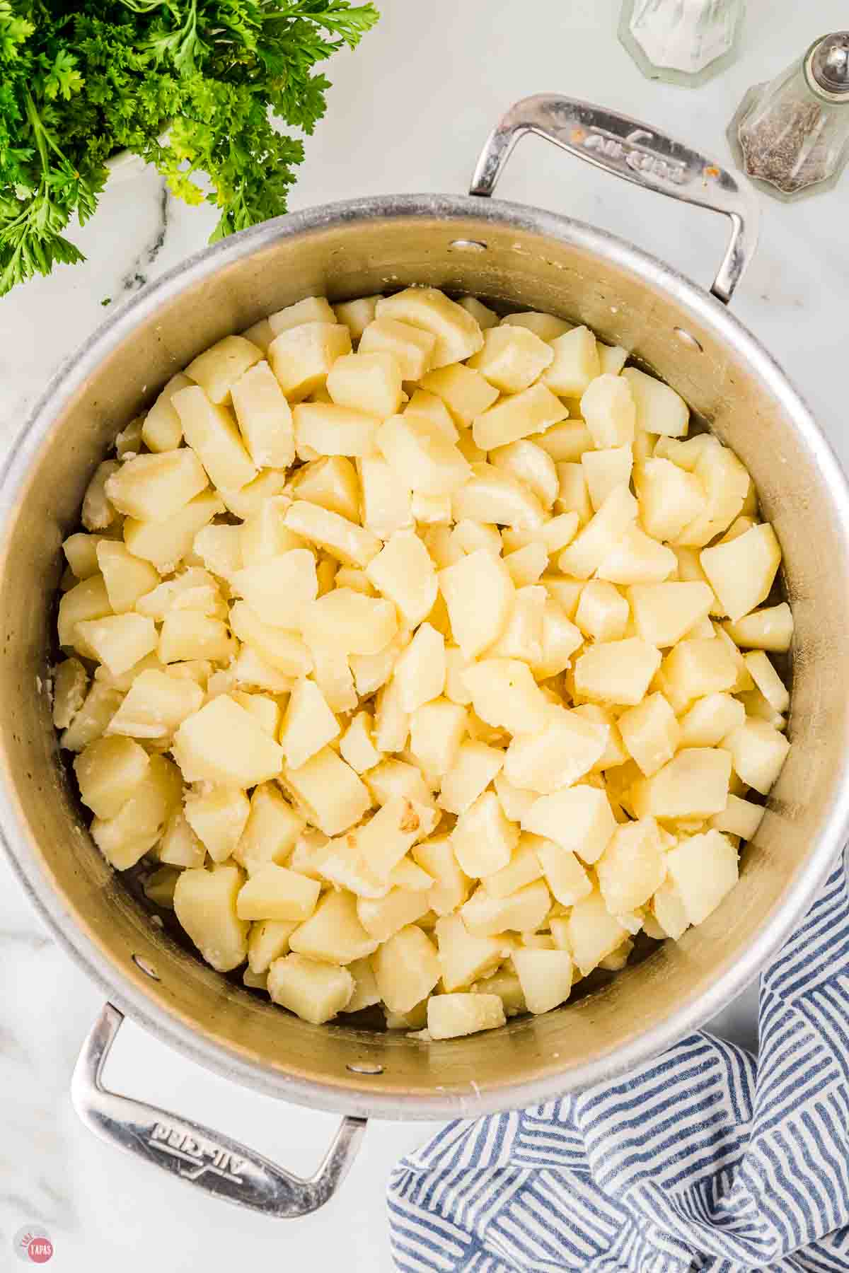 diced potatoes cooking in a large silver pot