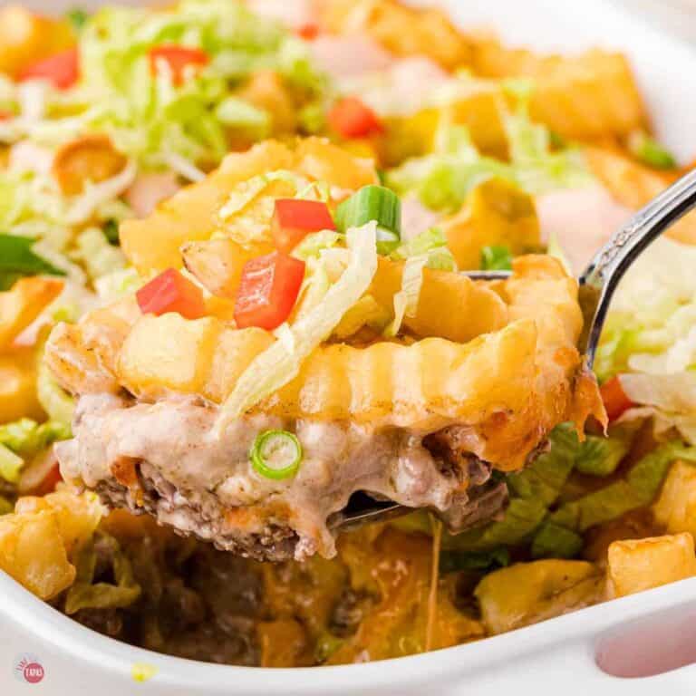scoop of cheeseburger casserole topped with french fries