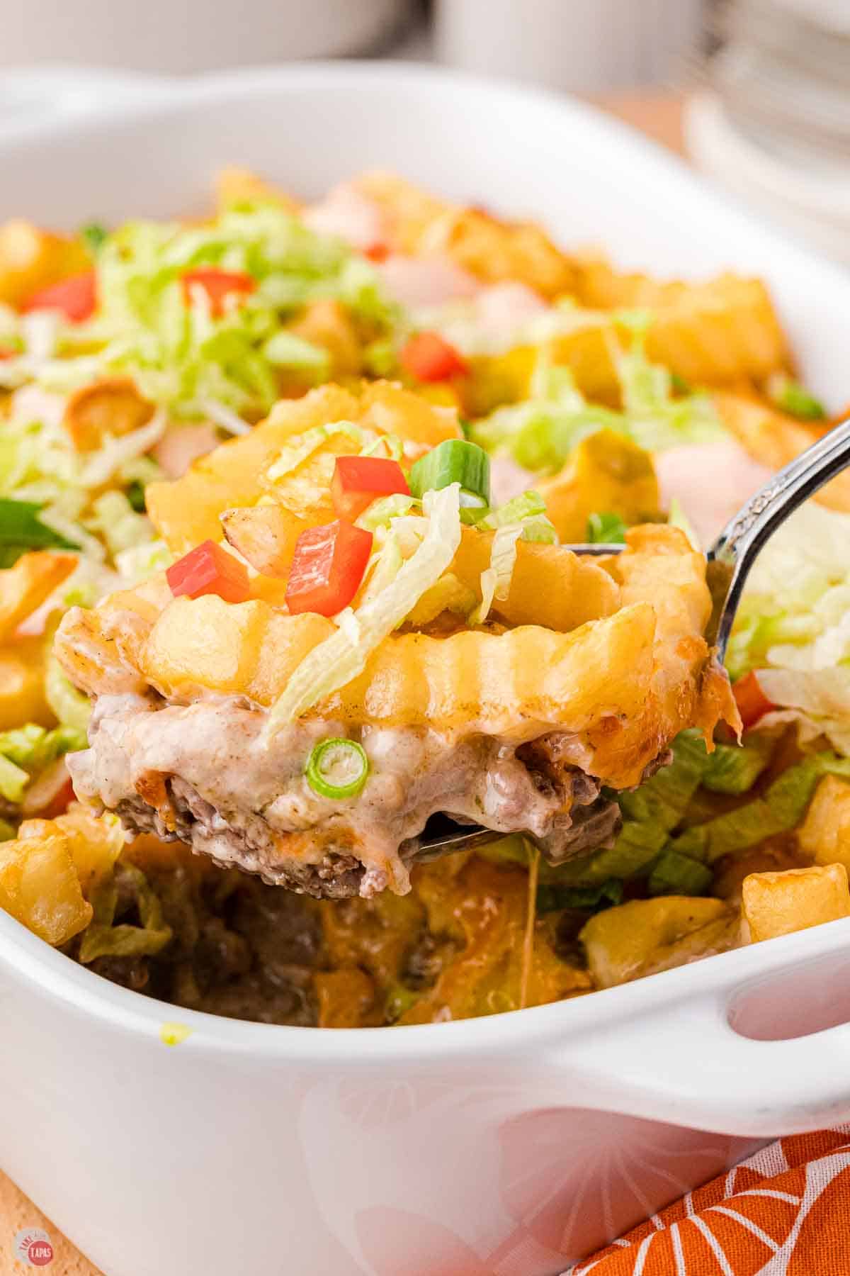 scoop of cheeseburger casserole topped with french fries