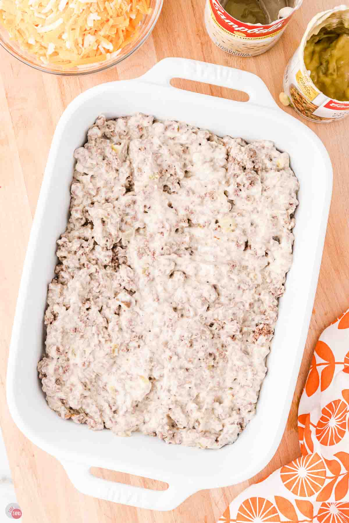 creamy cheeseburger mixture in a white casserole dish