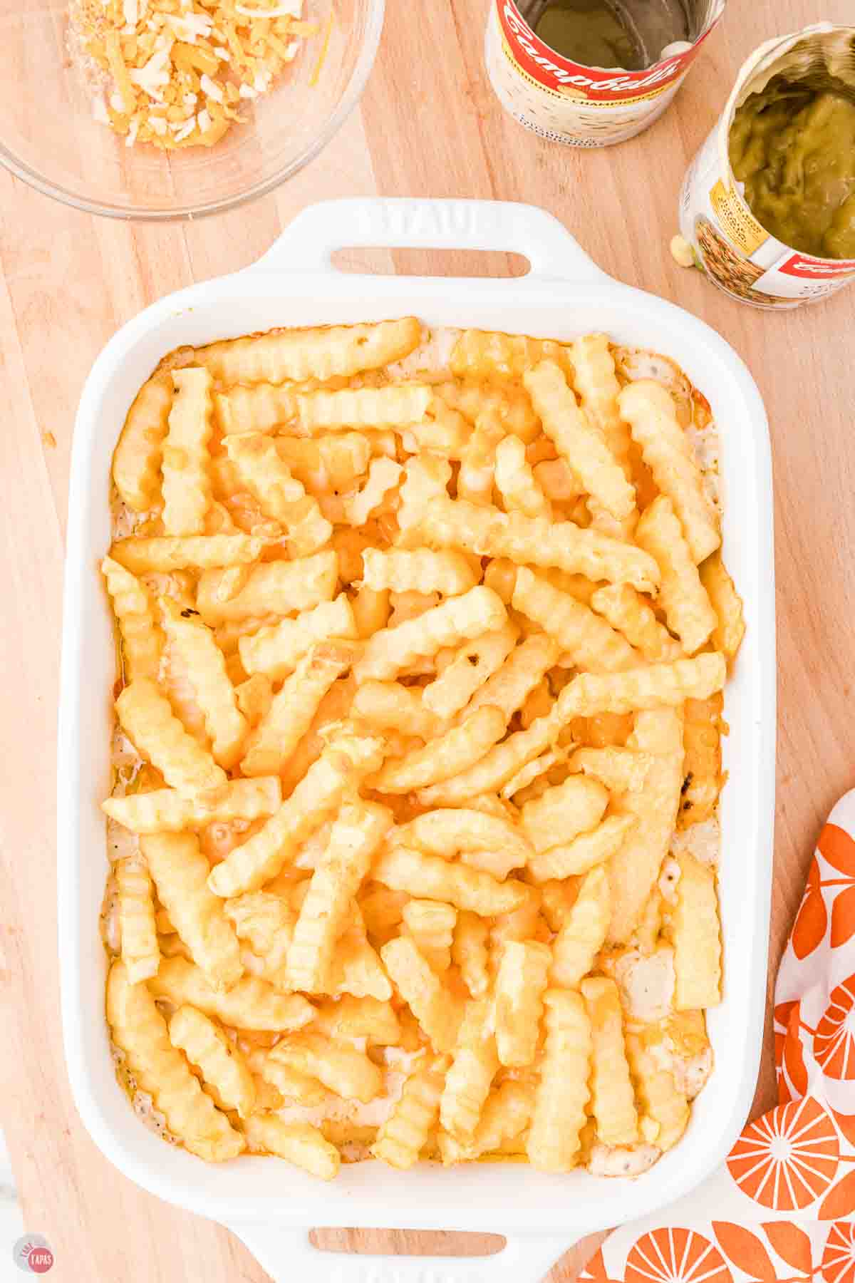 white casserole dish with a layer of frozen french fries