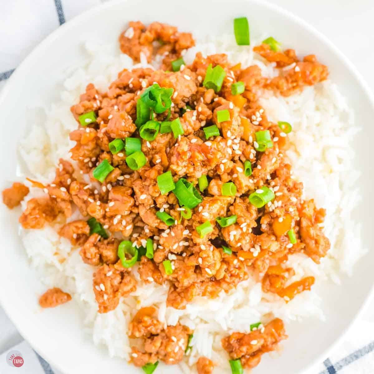 close up of orange chicken over steamed rice