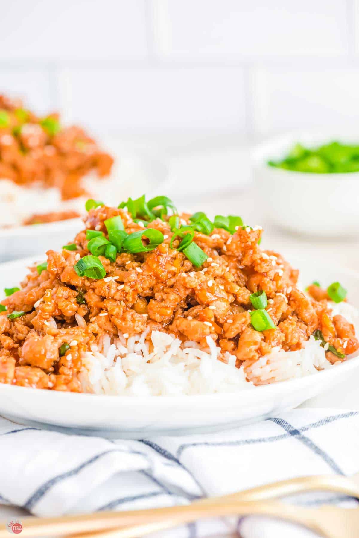 close up of orange chicken made with ground chicken over white rice