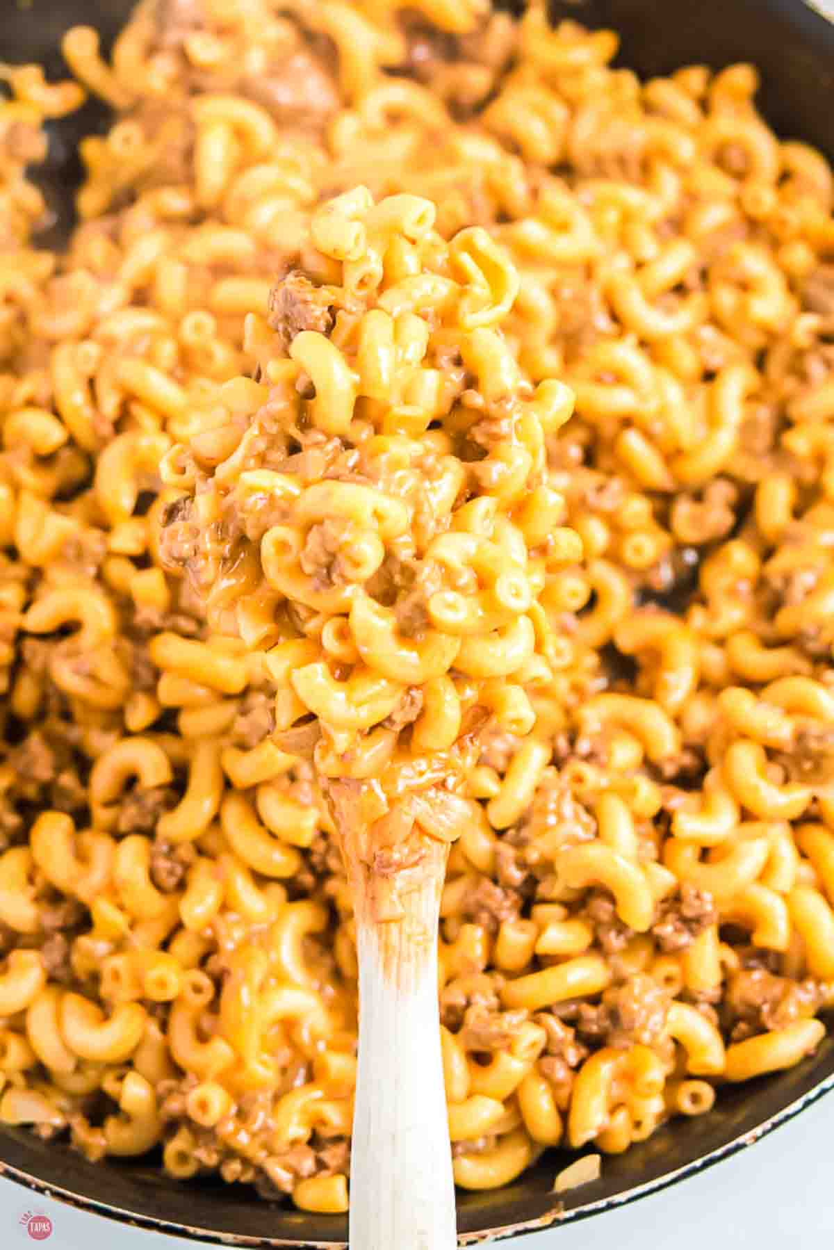 close up of hamburger helper on a wood spoon