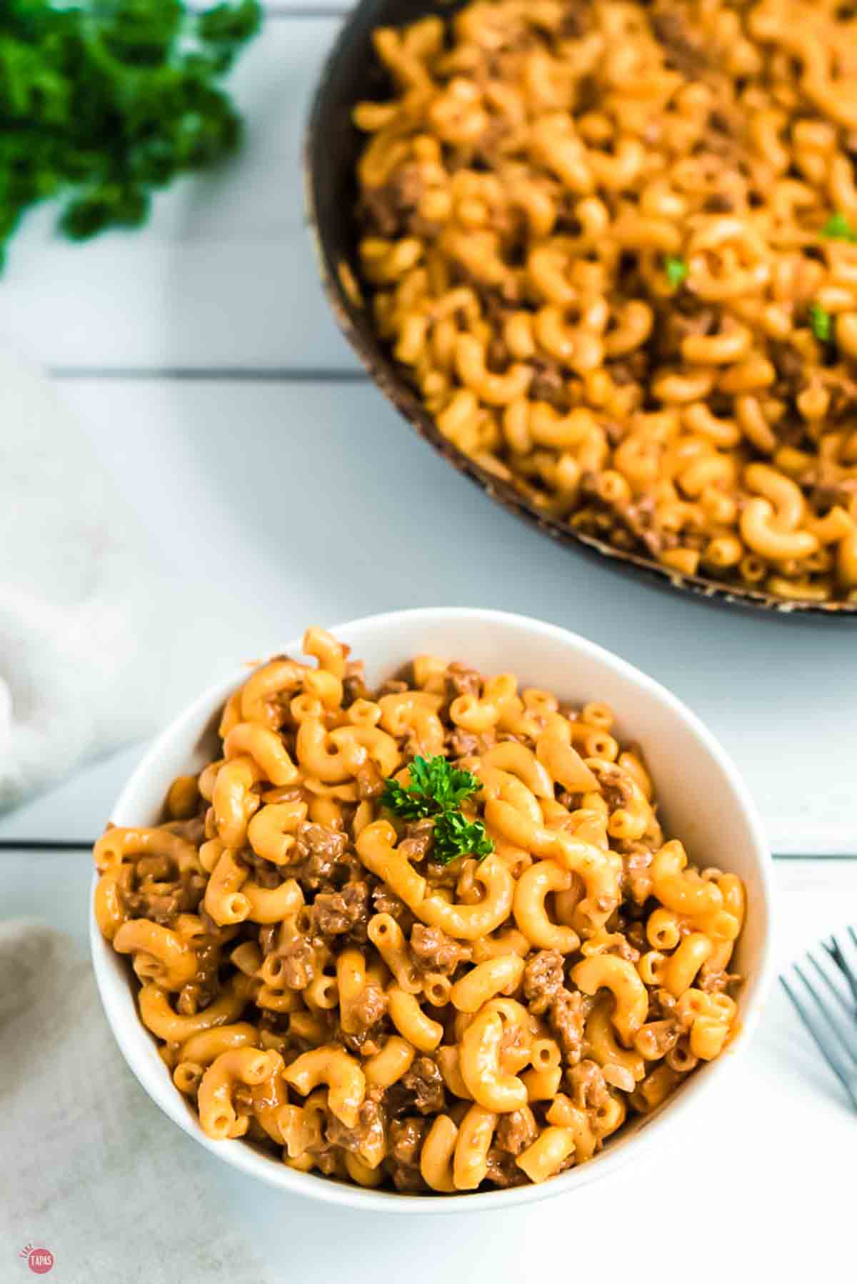 bowl of hamburger helper on a wood slat board