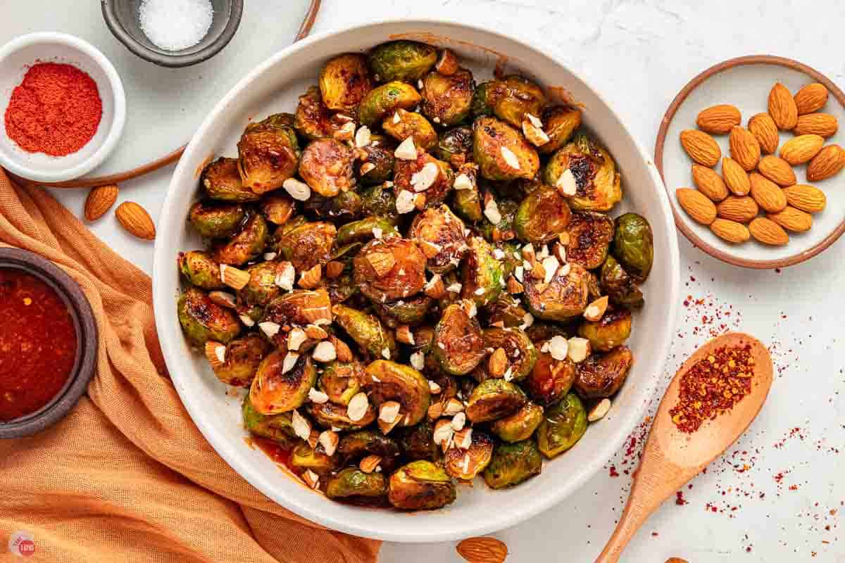 large white bowl filled with hot honey brussels sprouts