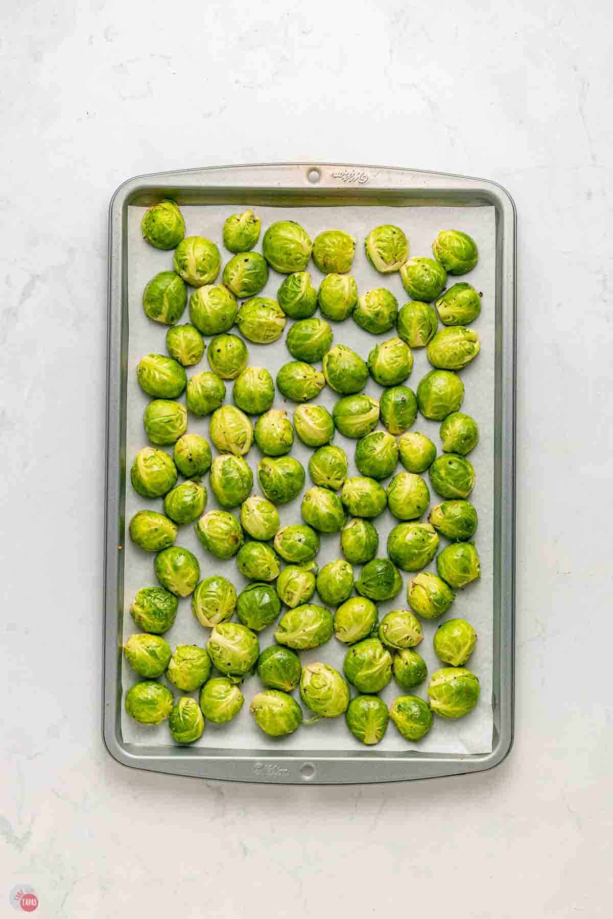 Brussels sprouts, cut in half, and placed cut side down on a baking sheet