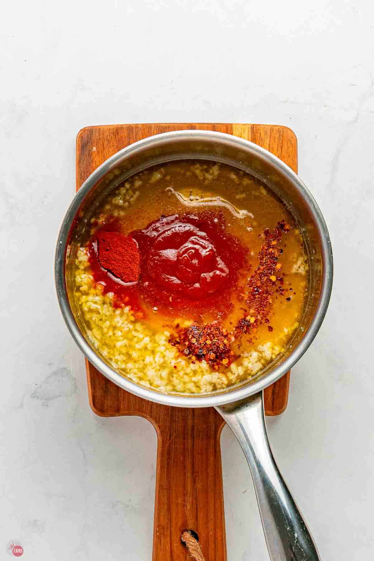 silver pot with a hot honey mixture simmering