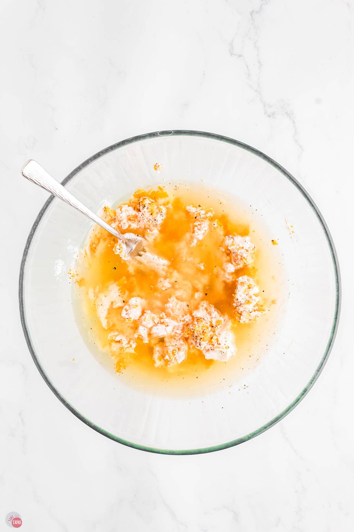 chicken and cheese mixture with broth in a clear bowl