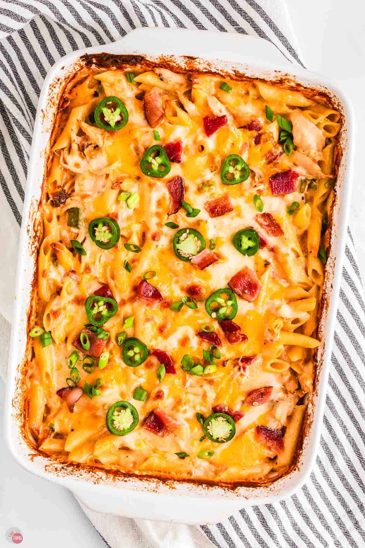 baked jalapeno popper chicken casserole on a blue and white napkin