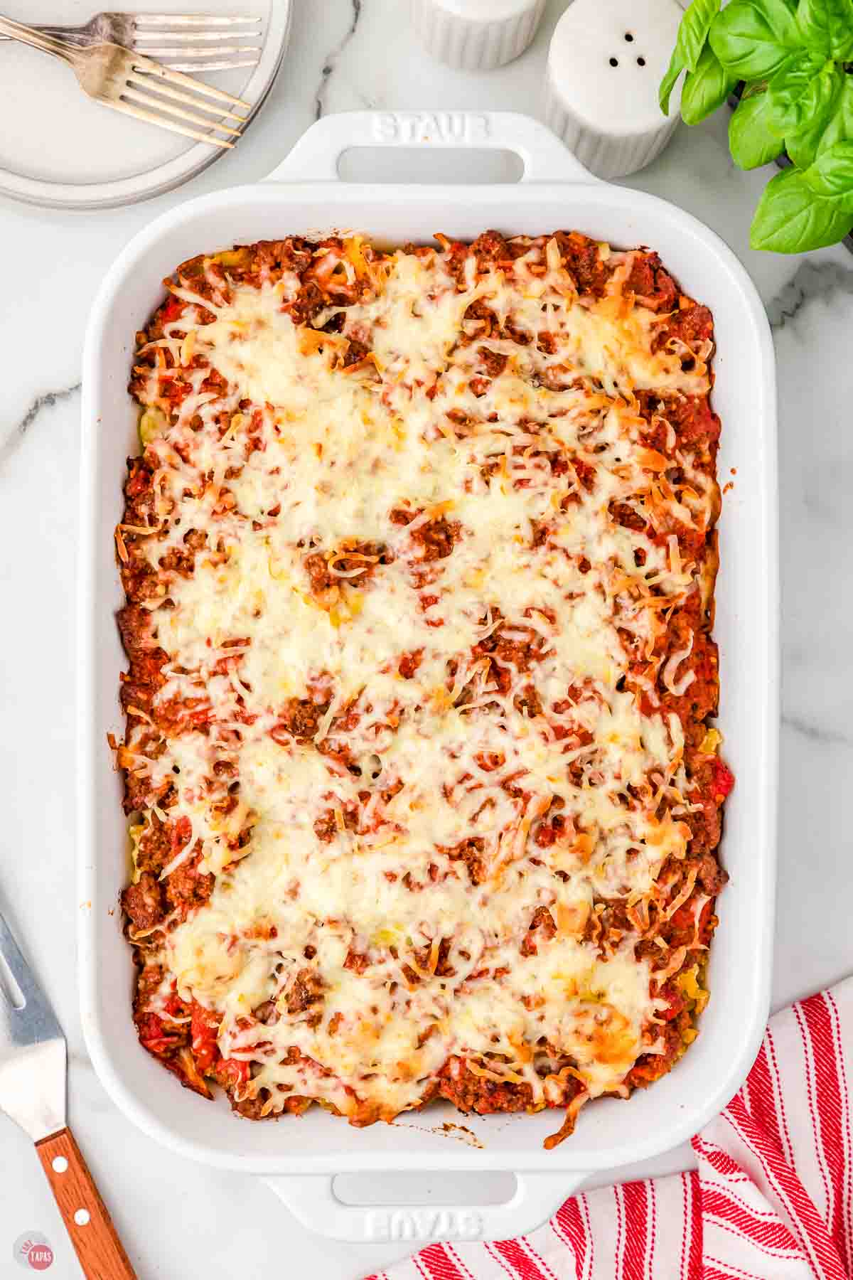 baked lasagna casserole in a white 9x13 baking dish