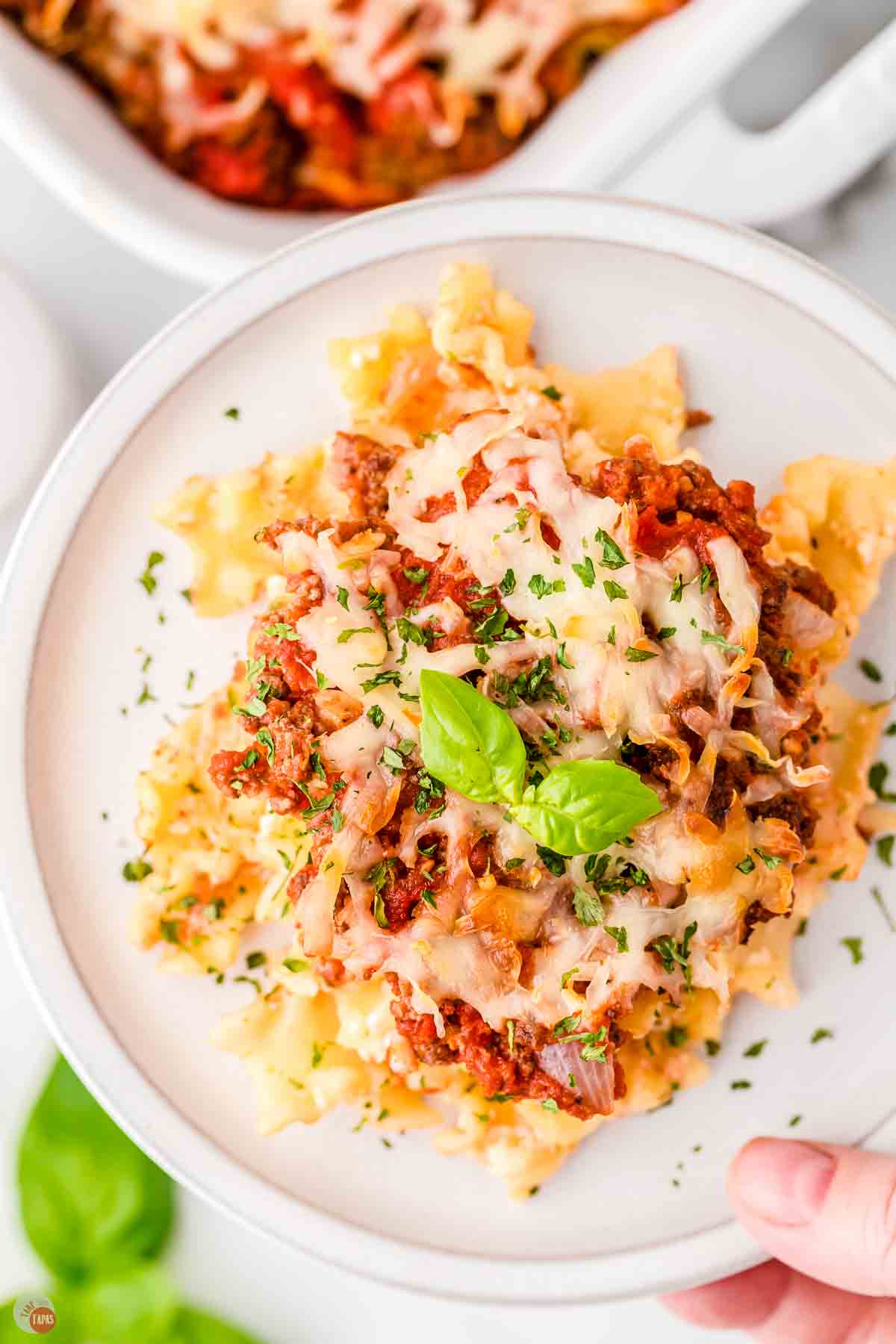 white plate with serving of lasagna casserole 
