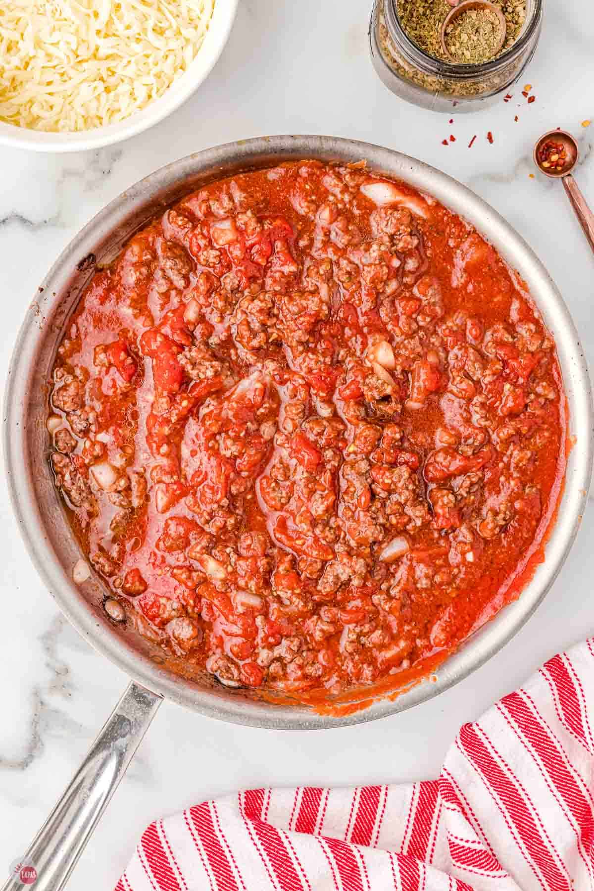 silver skillet full of meat sauce