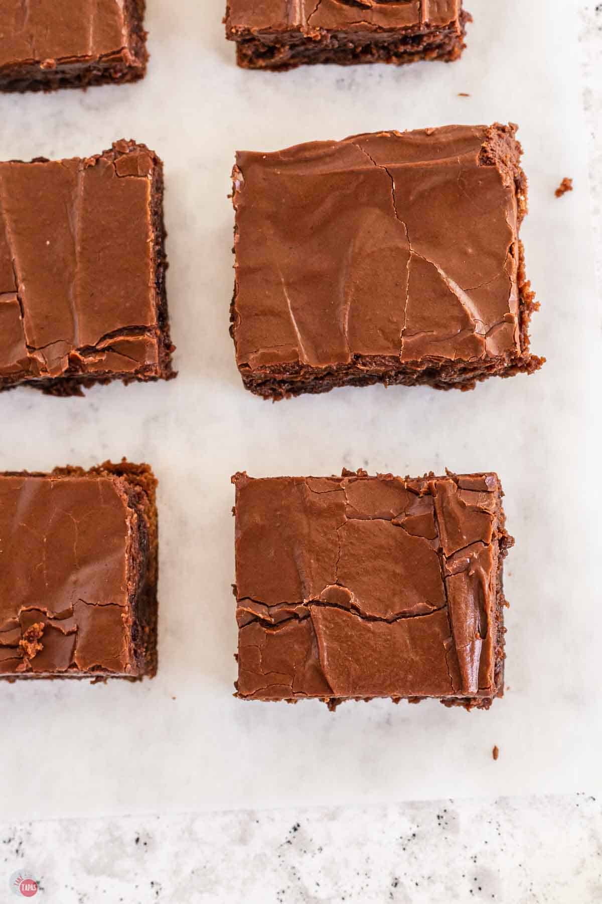 brownies cut into squares on parchment paper