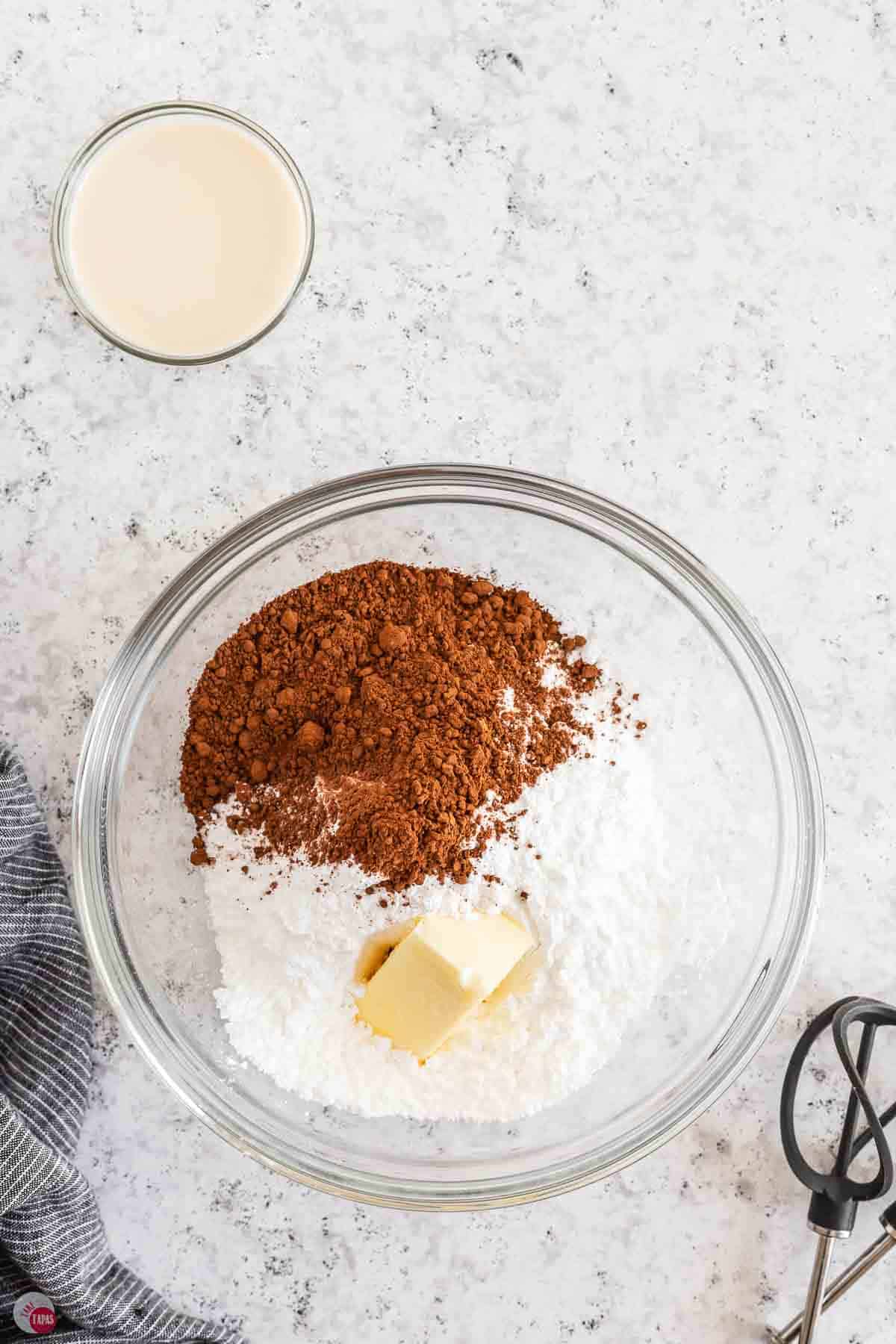 clear bowl with powdered sugar and cocoa powder