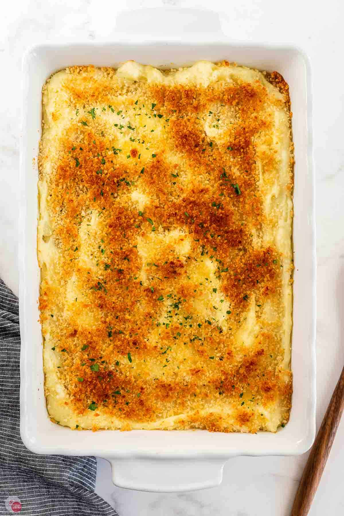 baked mashed potato gratin in a white casserole dish
