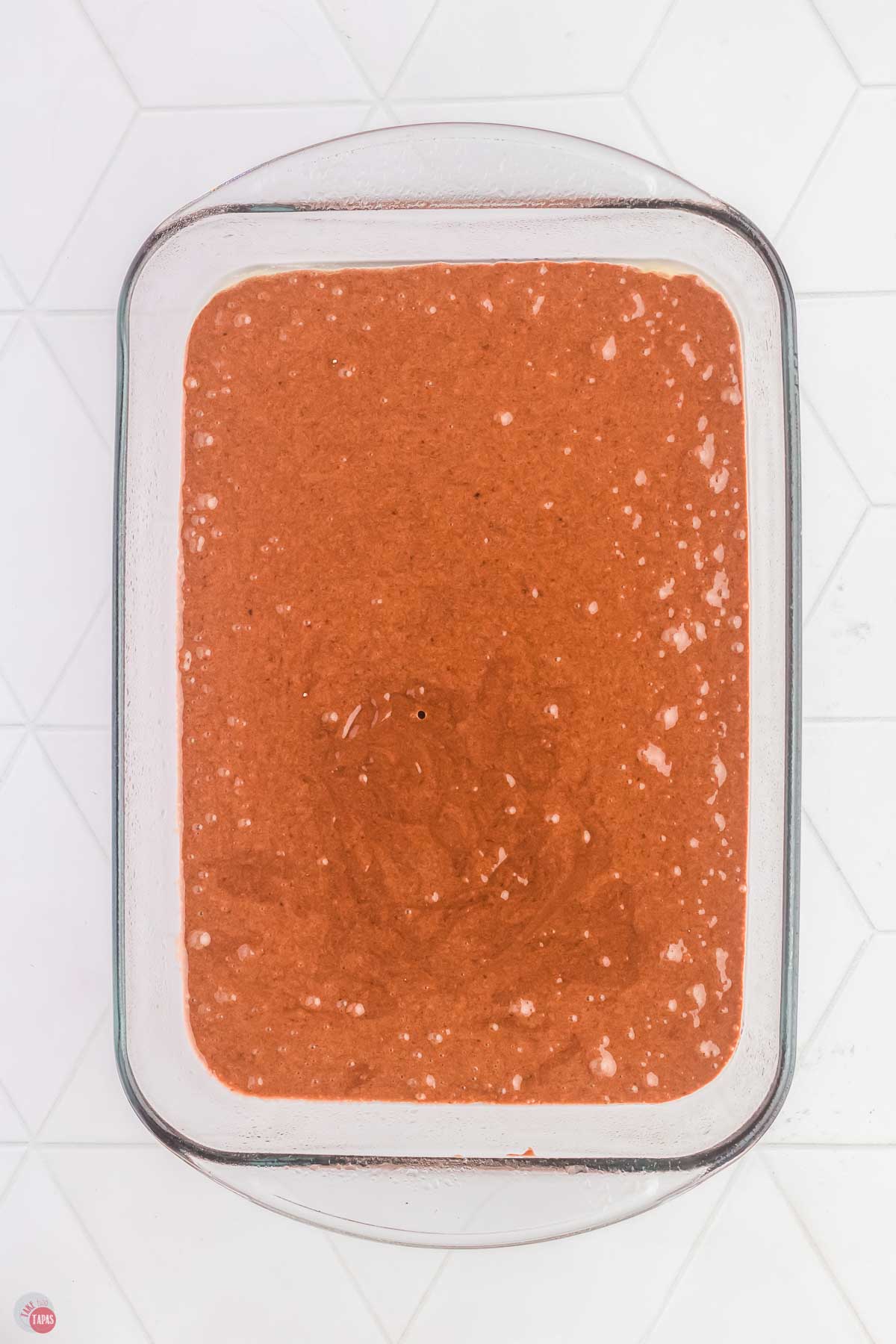 9x13 clear baking dish with cake batter in it