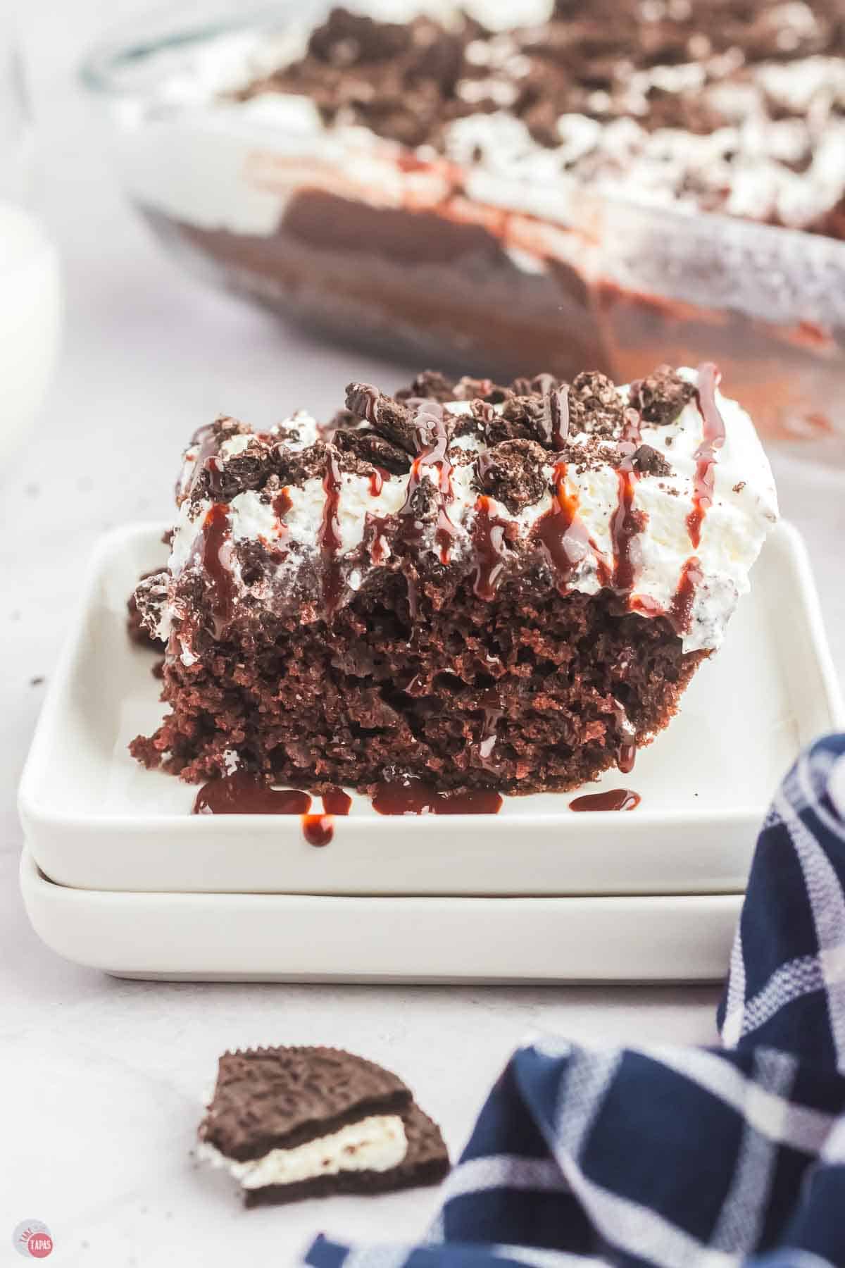 slice of chocolate cake on a stack of white plates